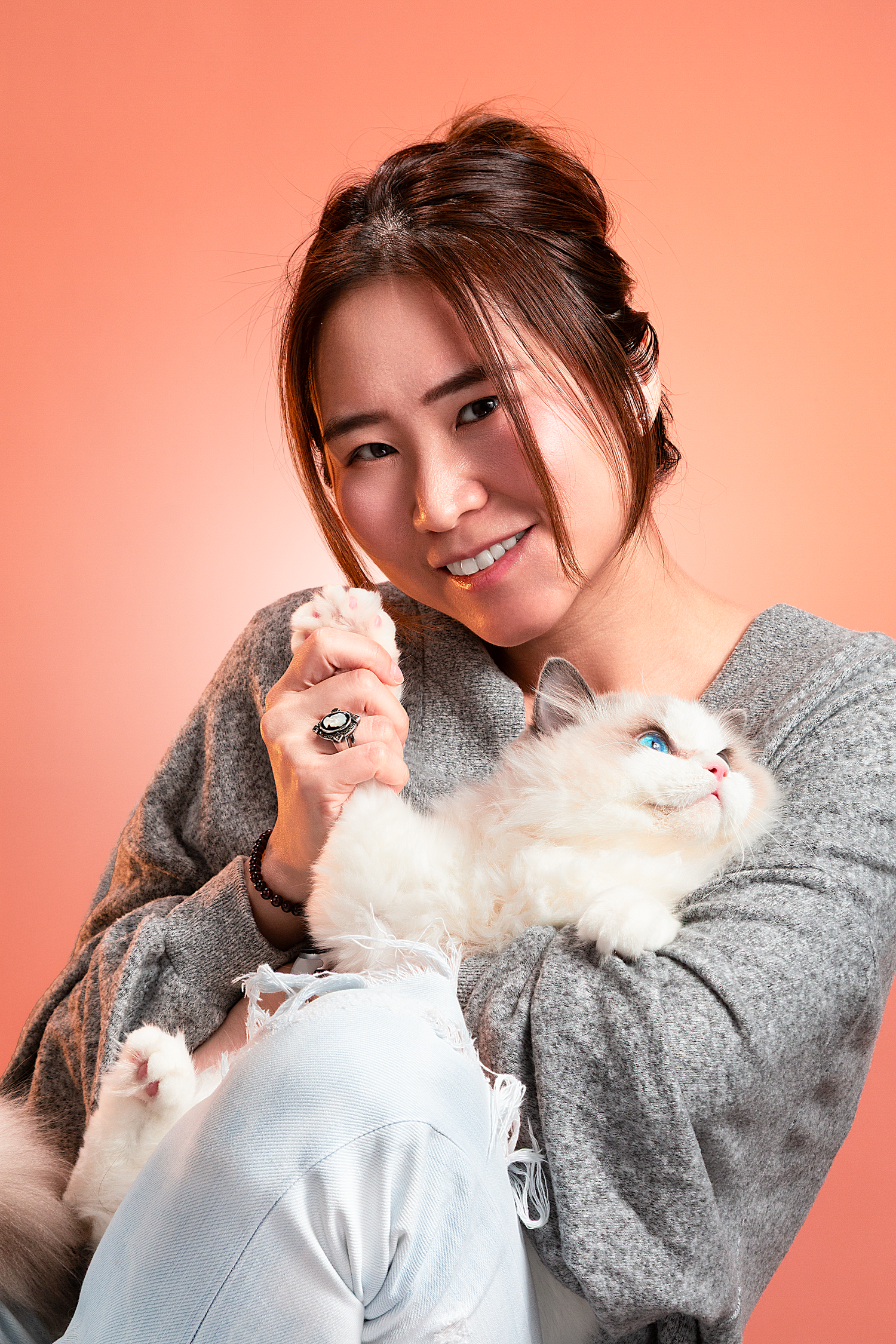 Studio pet photography featuring a woman and her cat captured in a warm and natural portrait session.