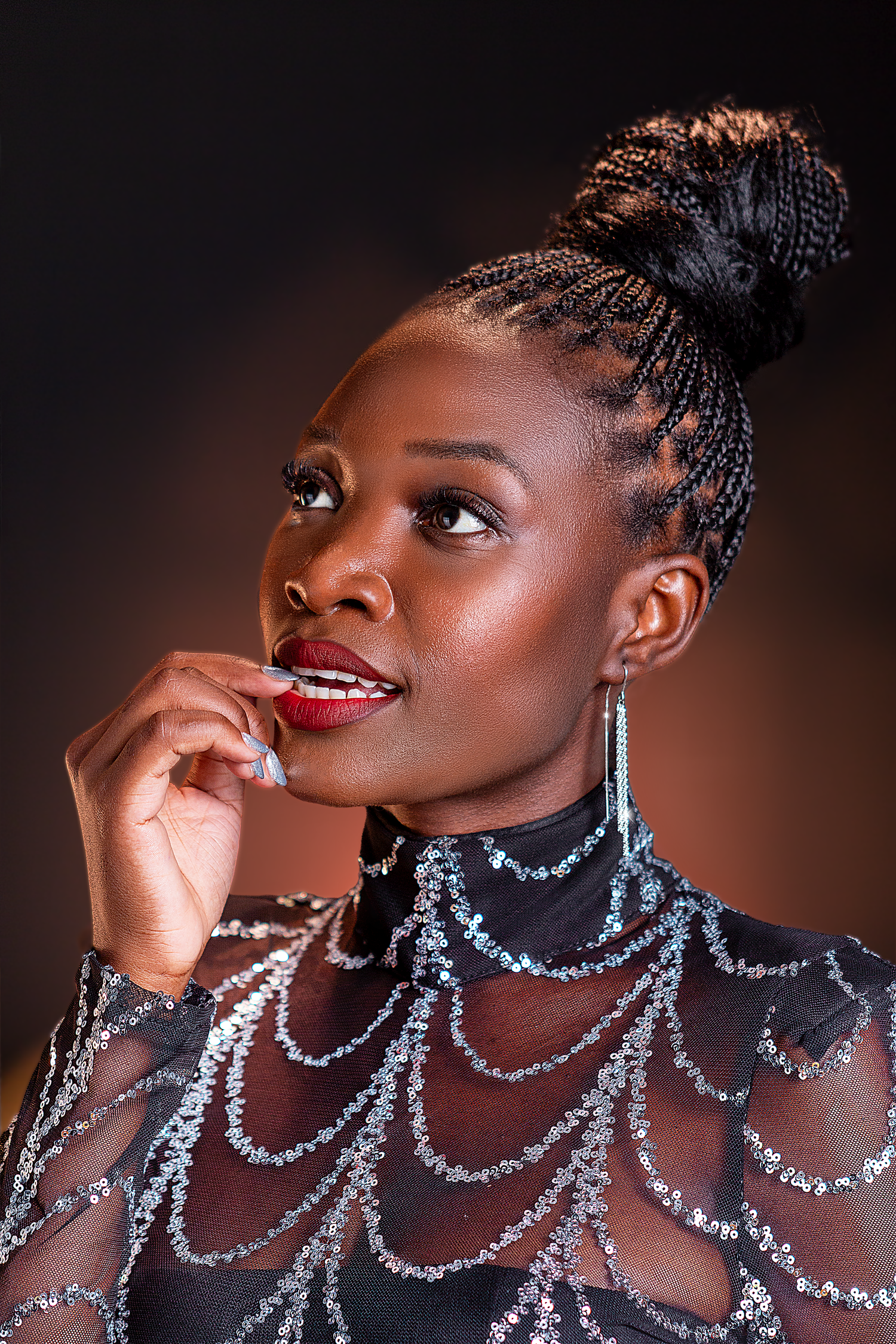 Professional beauty portrait featuring a female model photographed with elegant styling and dramatic studio lighting.