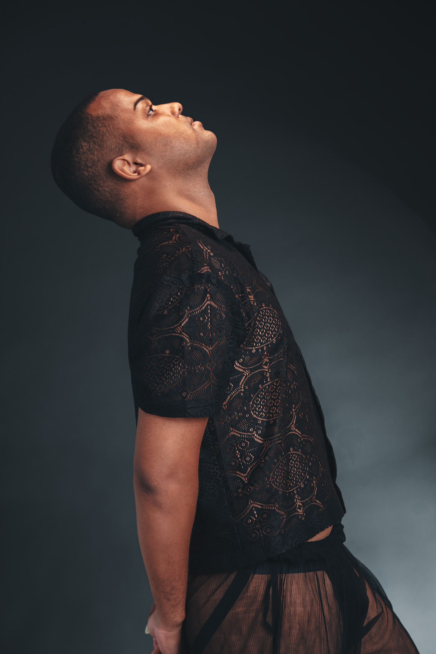 Dramatic editorial portrait of a male artist photographed with cinematic lighting in a professional Bangkok studio.