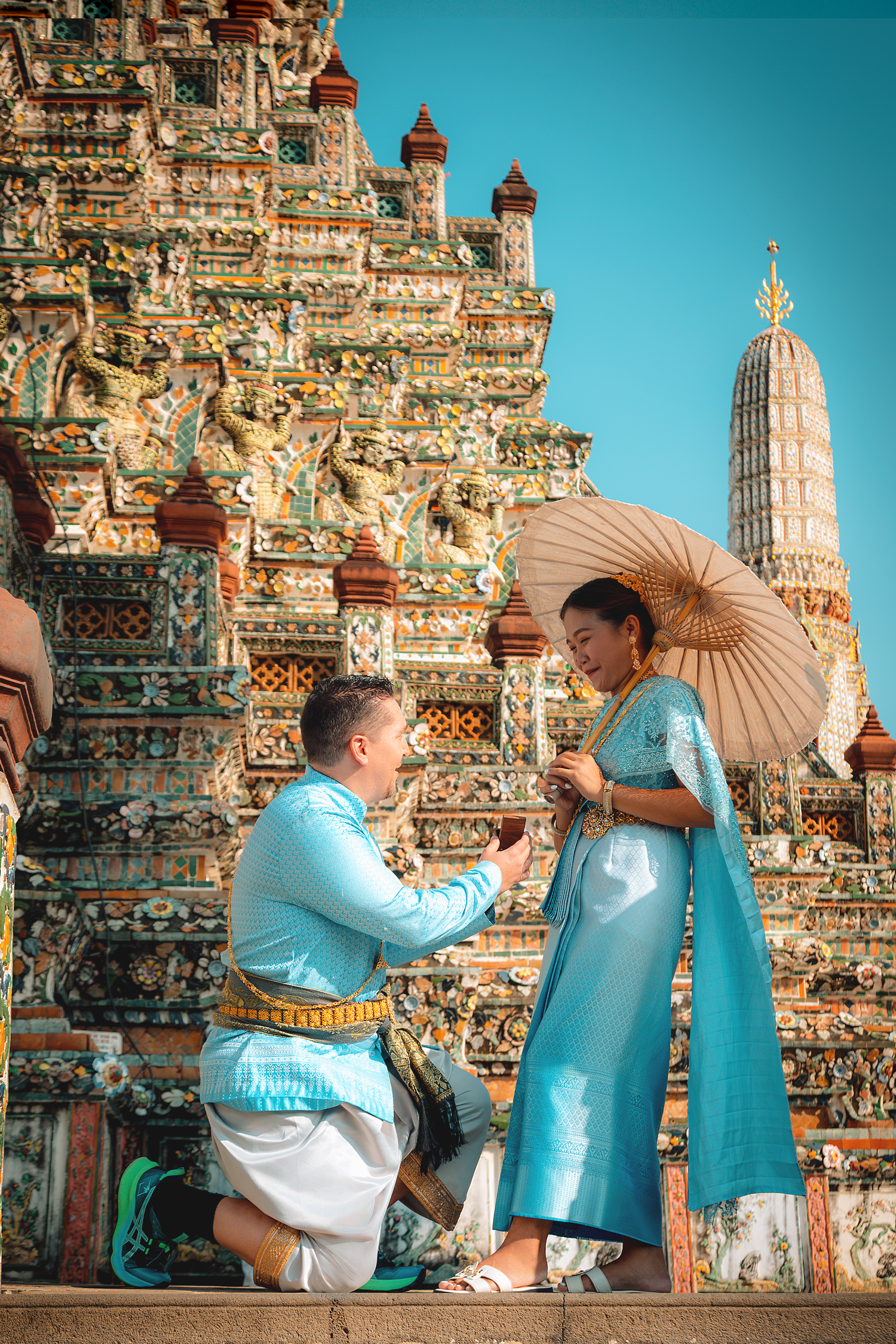 Surprise proposal photography at Wat Arun capturing the moment of engagement in Bangkok, Thailand.