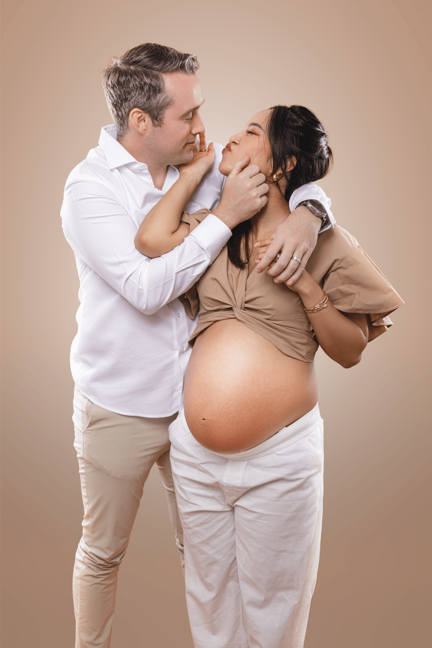 Maternity portrait session featuring an expecting couple celebrating their pregnancy together.
