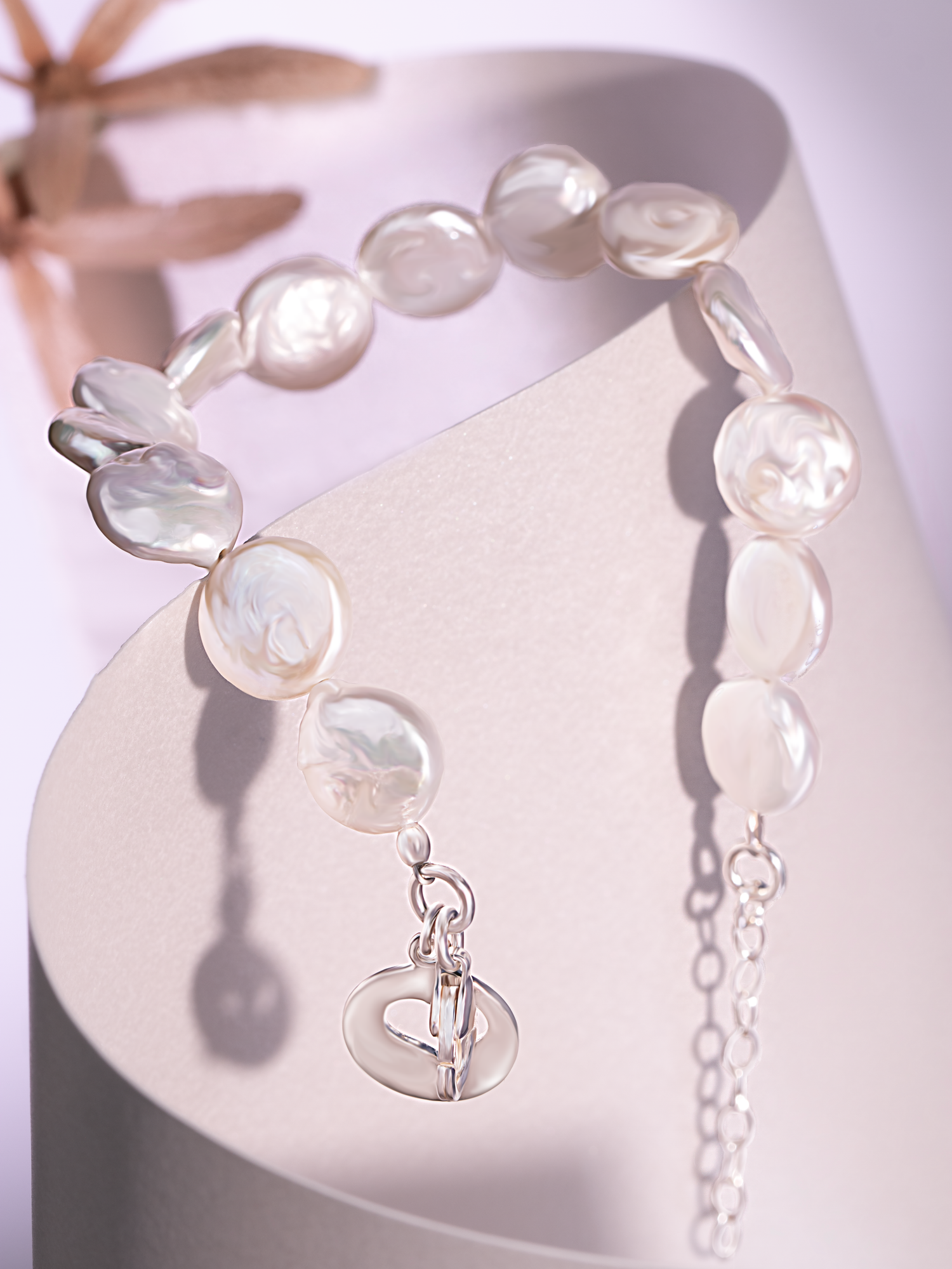 Luxury bracelet photography featuring pearl-style jewelry captured with soft shadows and premium product styling.