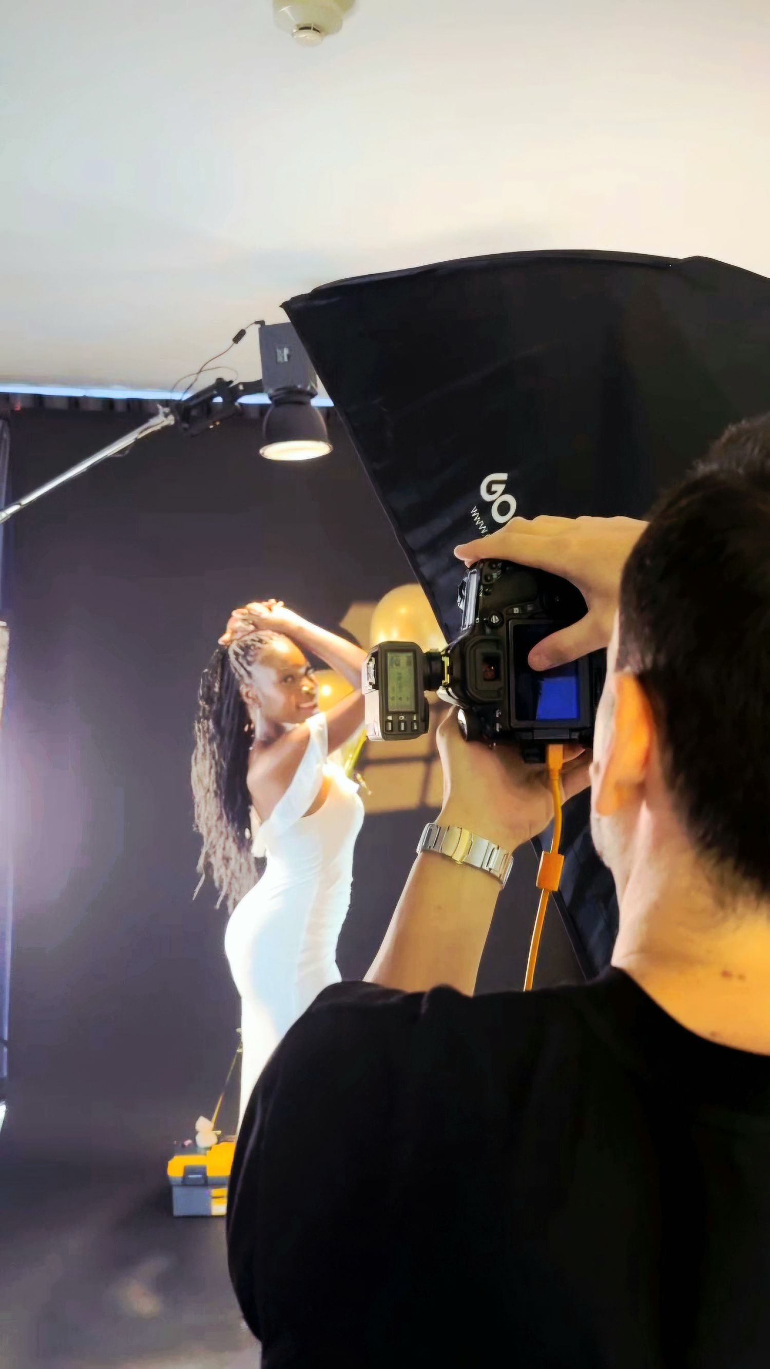 Behind-the-scenes photography showing a professional portrait photoshoot at The Bangkok Photographer’s Studio.