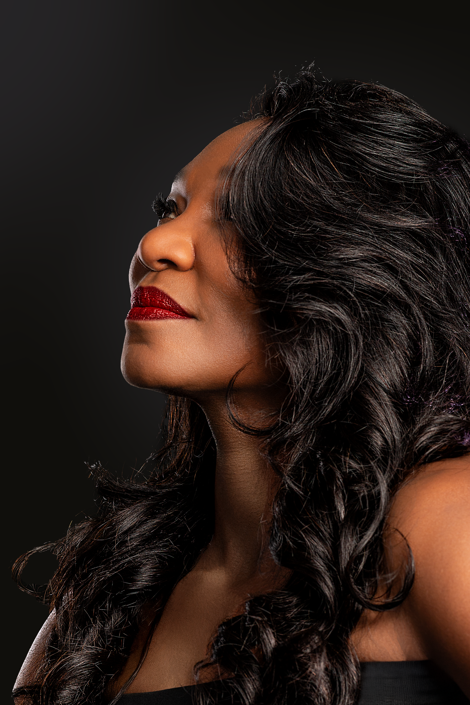 Beauty portrait photography featuring a female model captured with elegant side-profile lighting.