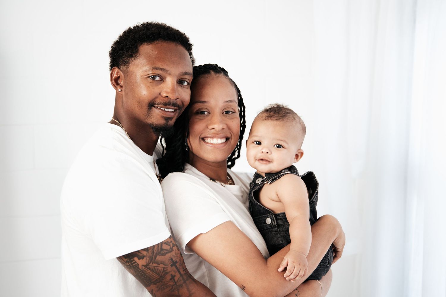 Heartwarming family portrait showing affection against clean white backdrop.
