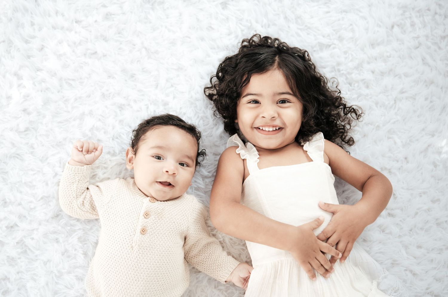 A series of tender family portraits against a light gray backdrop showing intimate moments.