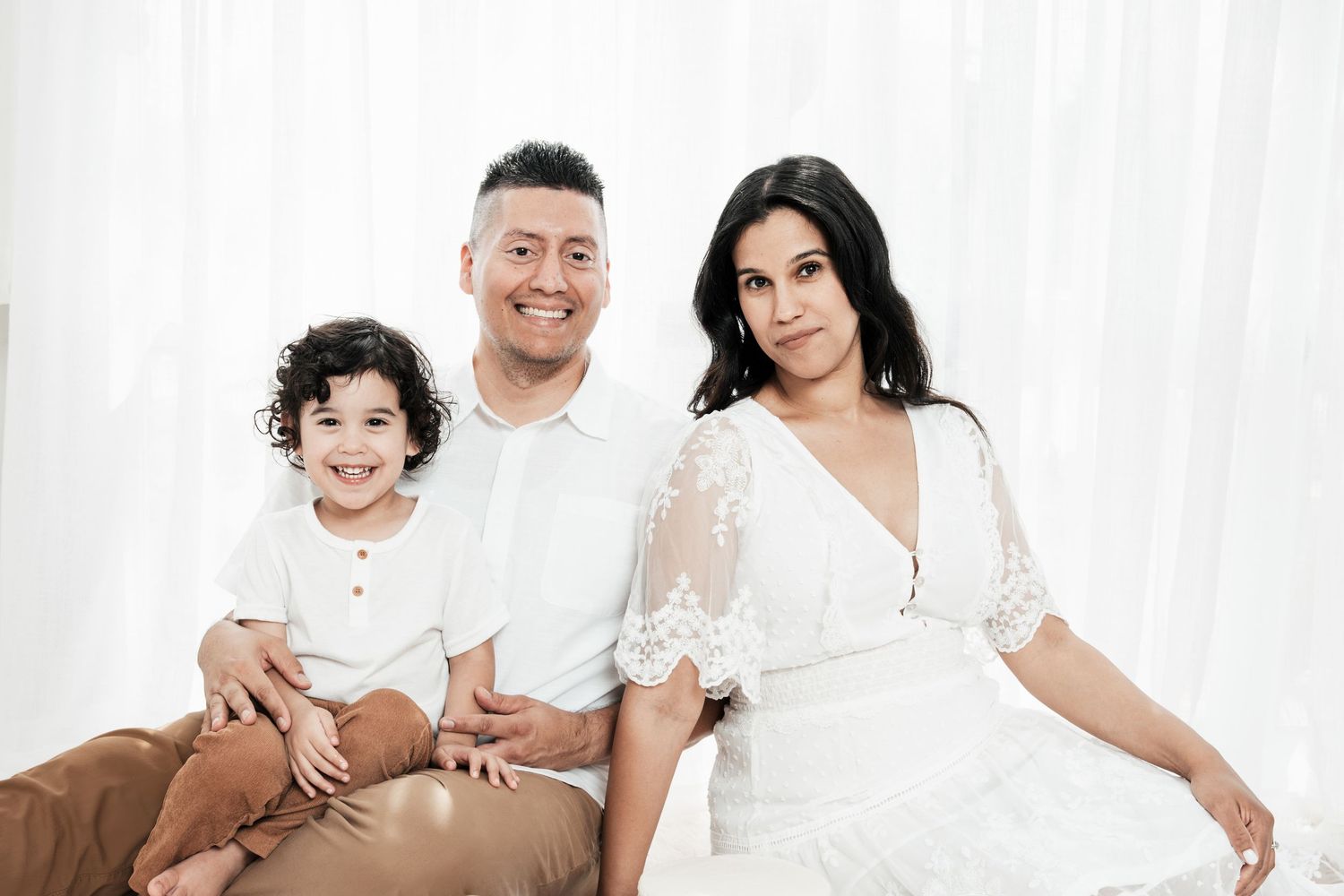 Collection of family portraits showing affectionate moments in coordinated white outfits.