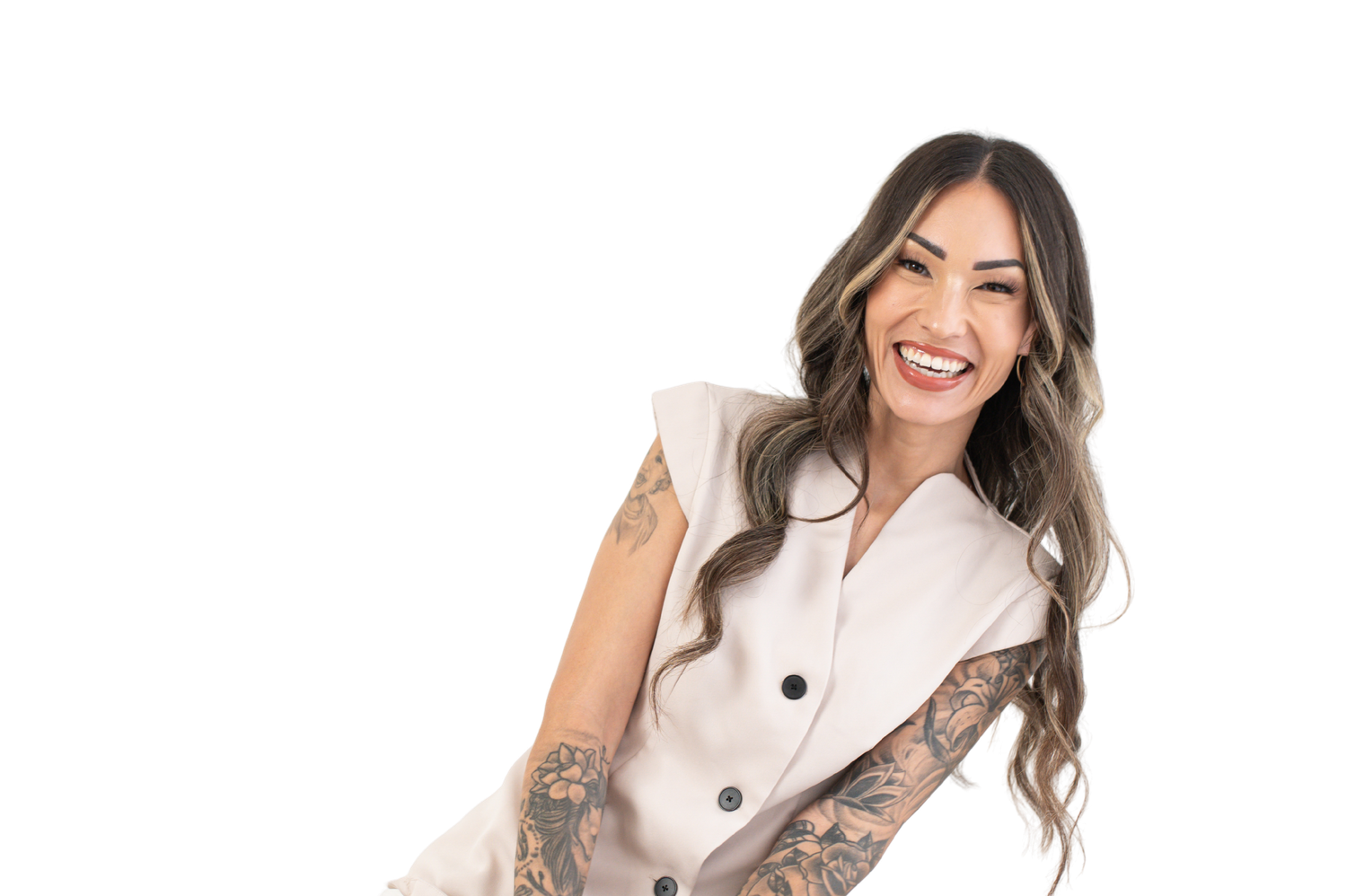 Professional woman in white blazer smiling against light background.