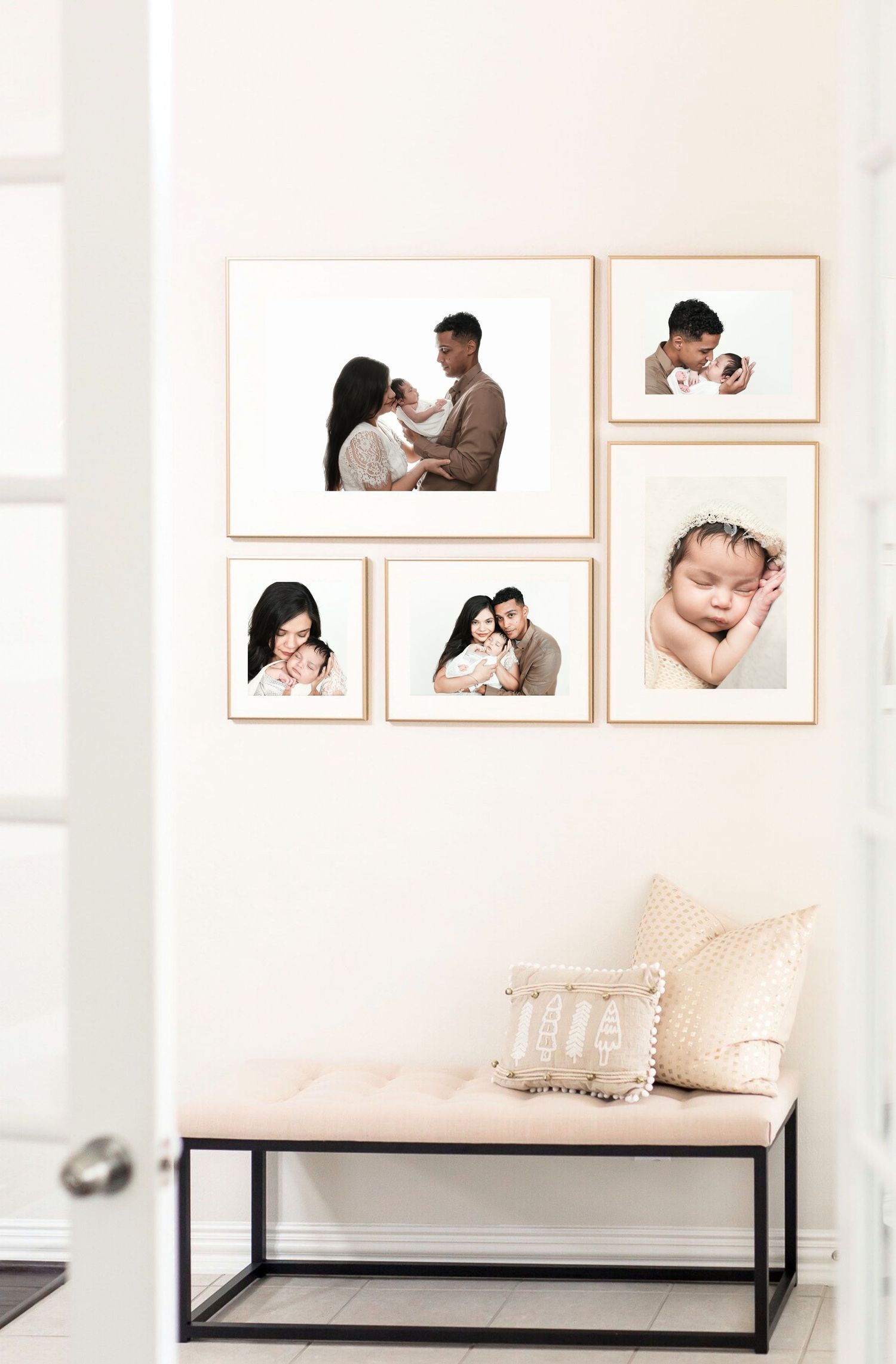 Modern photography studio display with framed family portraits on white walls.