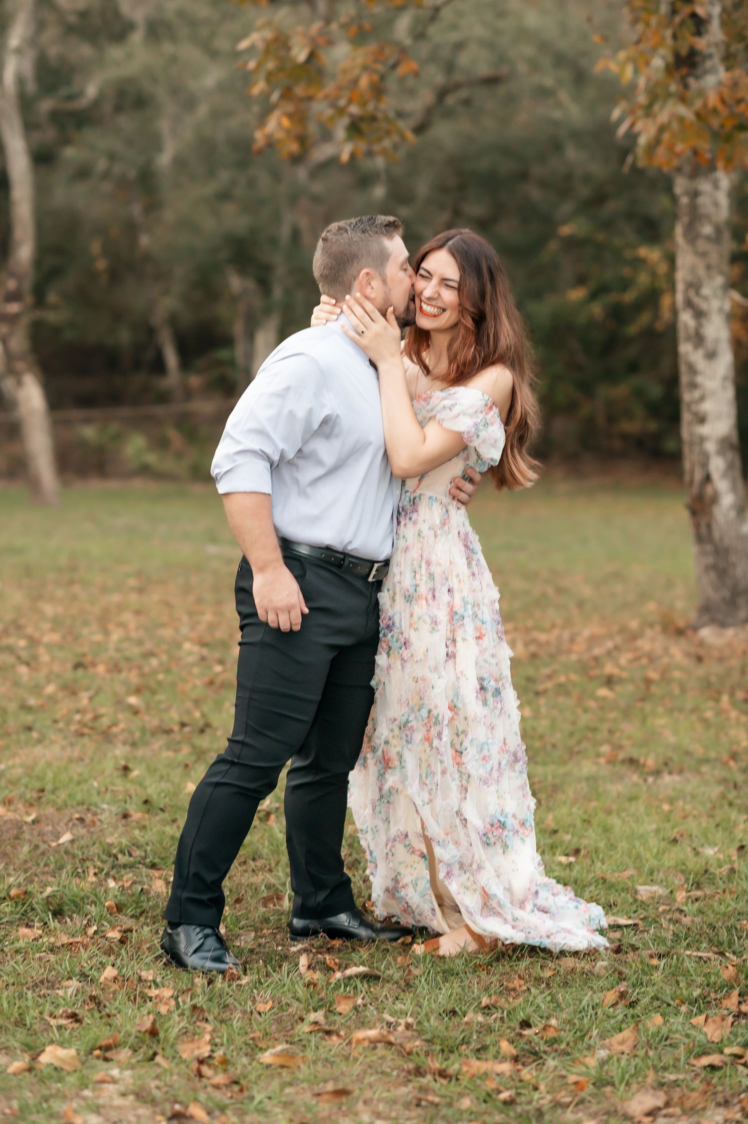 Romantic couple photos in floral dress and formal wear among fall foliage.