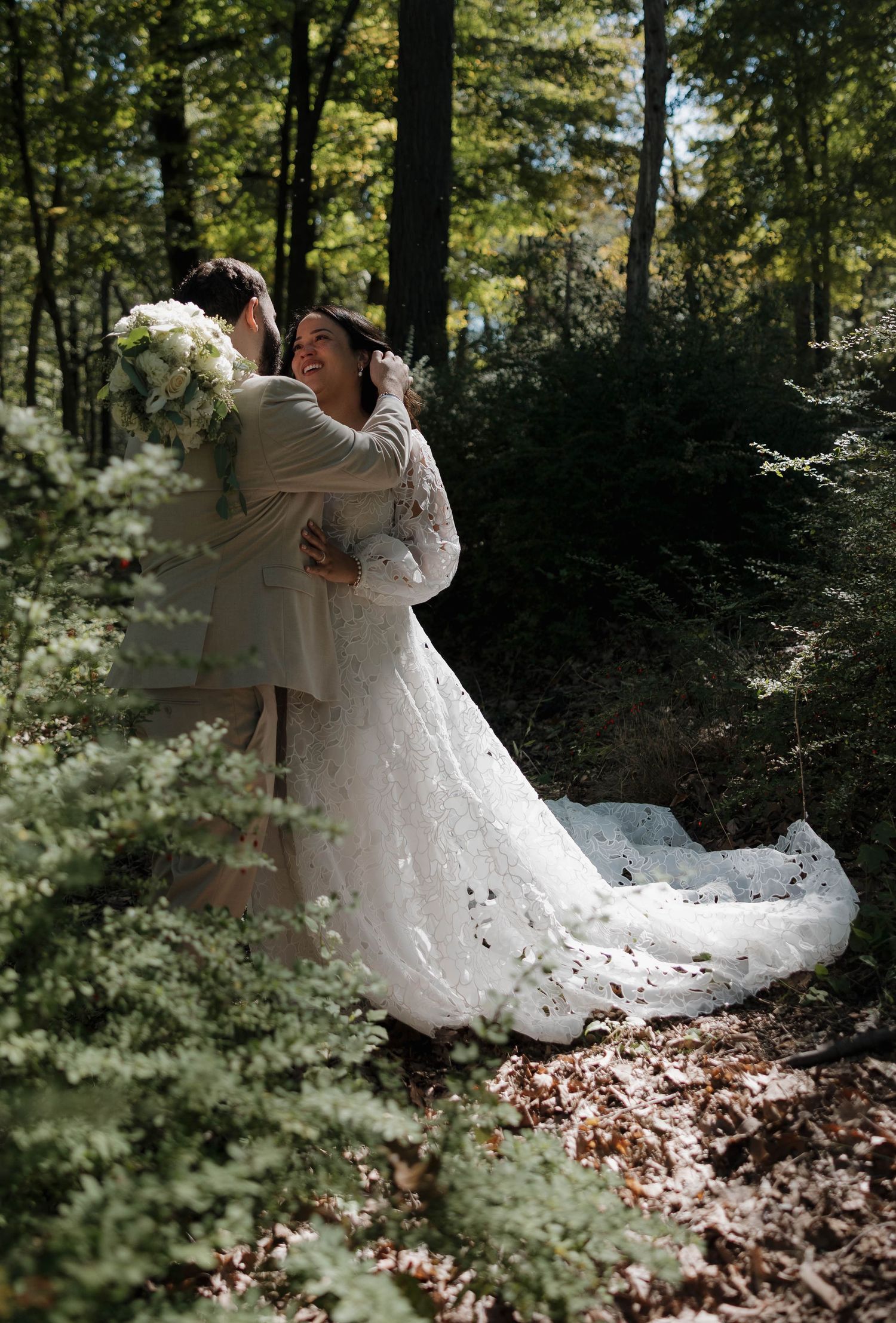 The bride's lace dress swirls gracefully during a forest dance sequence.