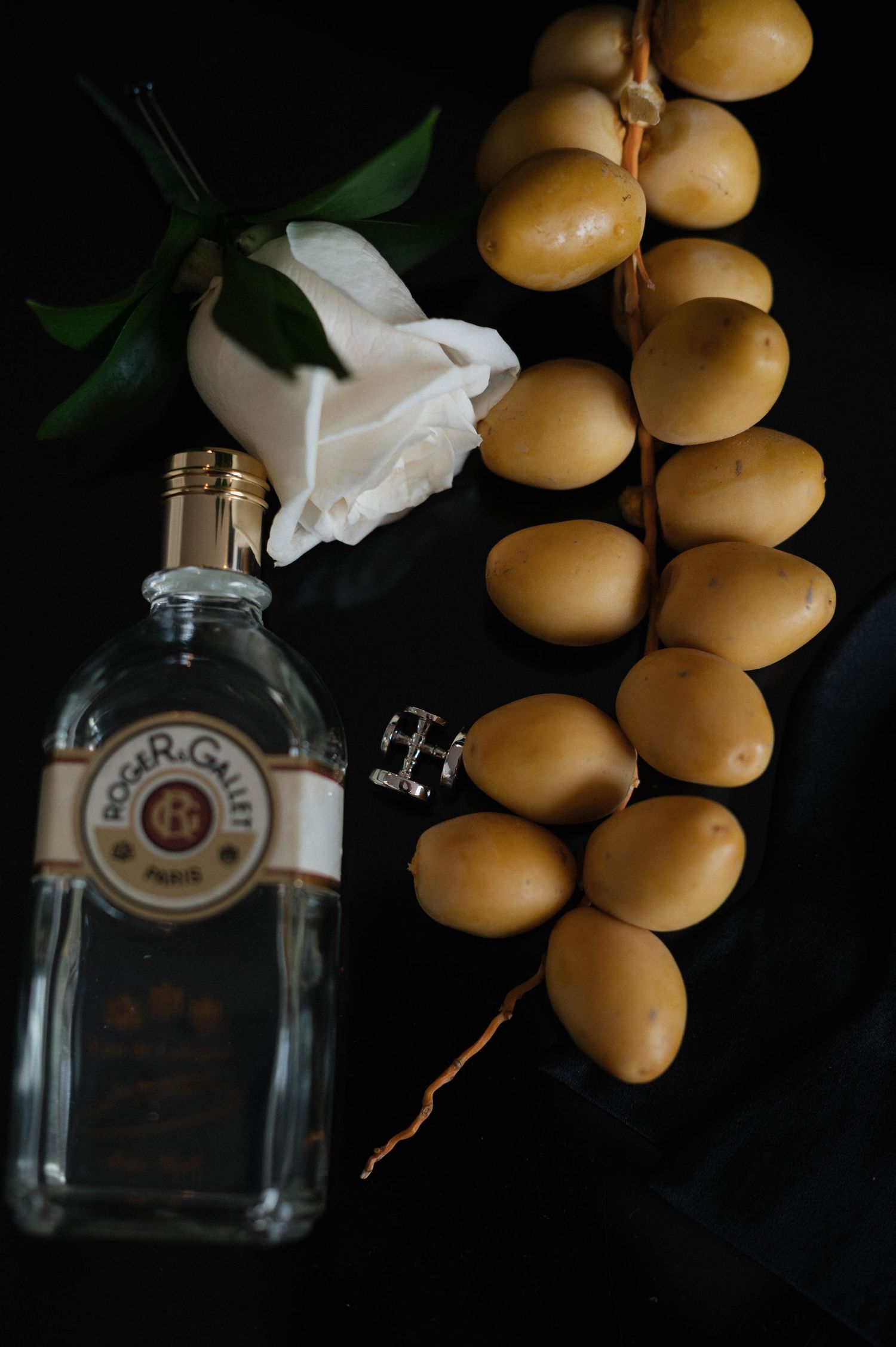 Fresh lemons and glass bottles arranged in moody still life composition.
