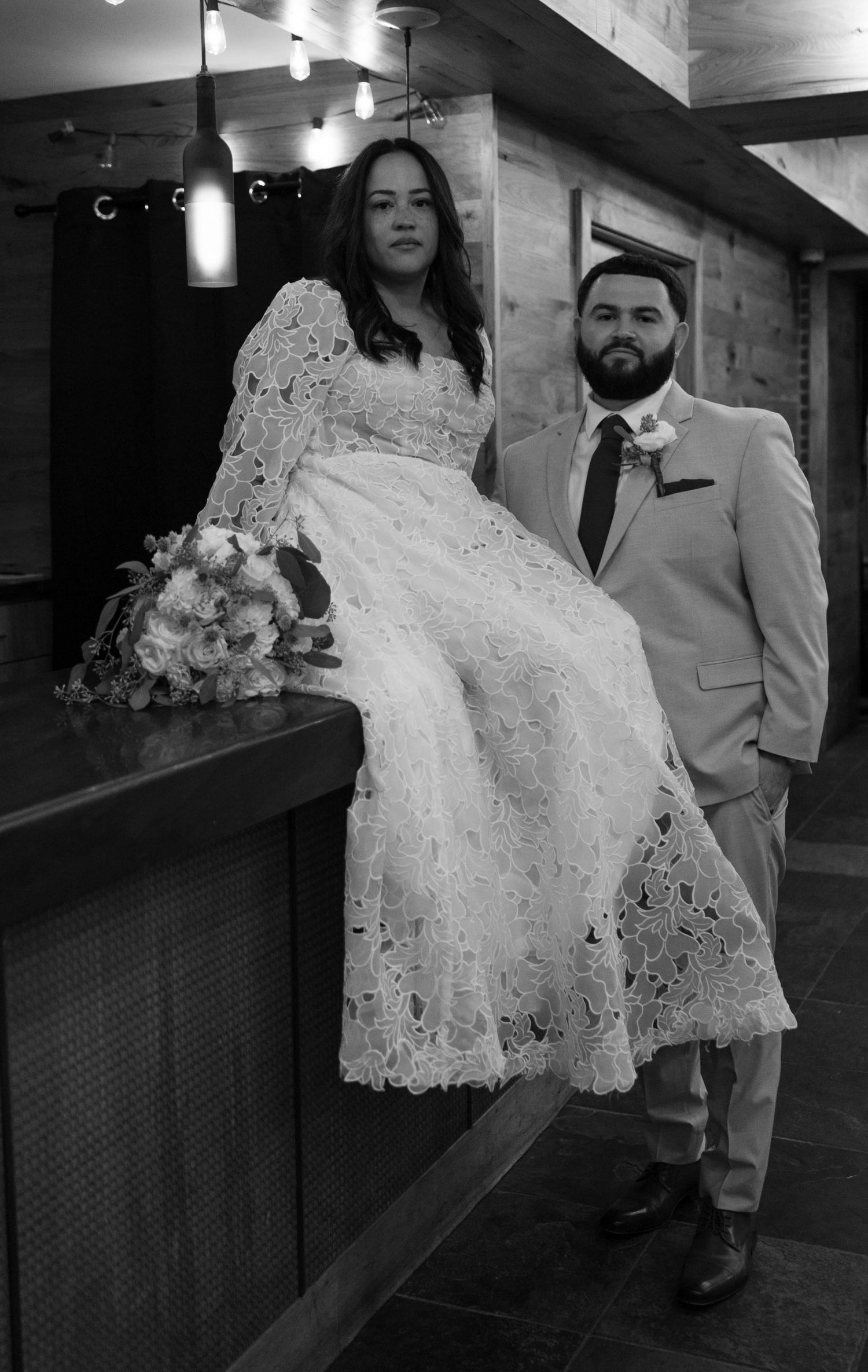 An indoor wedding dance scene with elegant lighting and rustic wooden details.