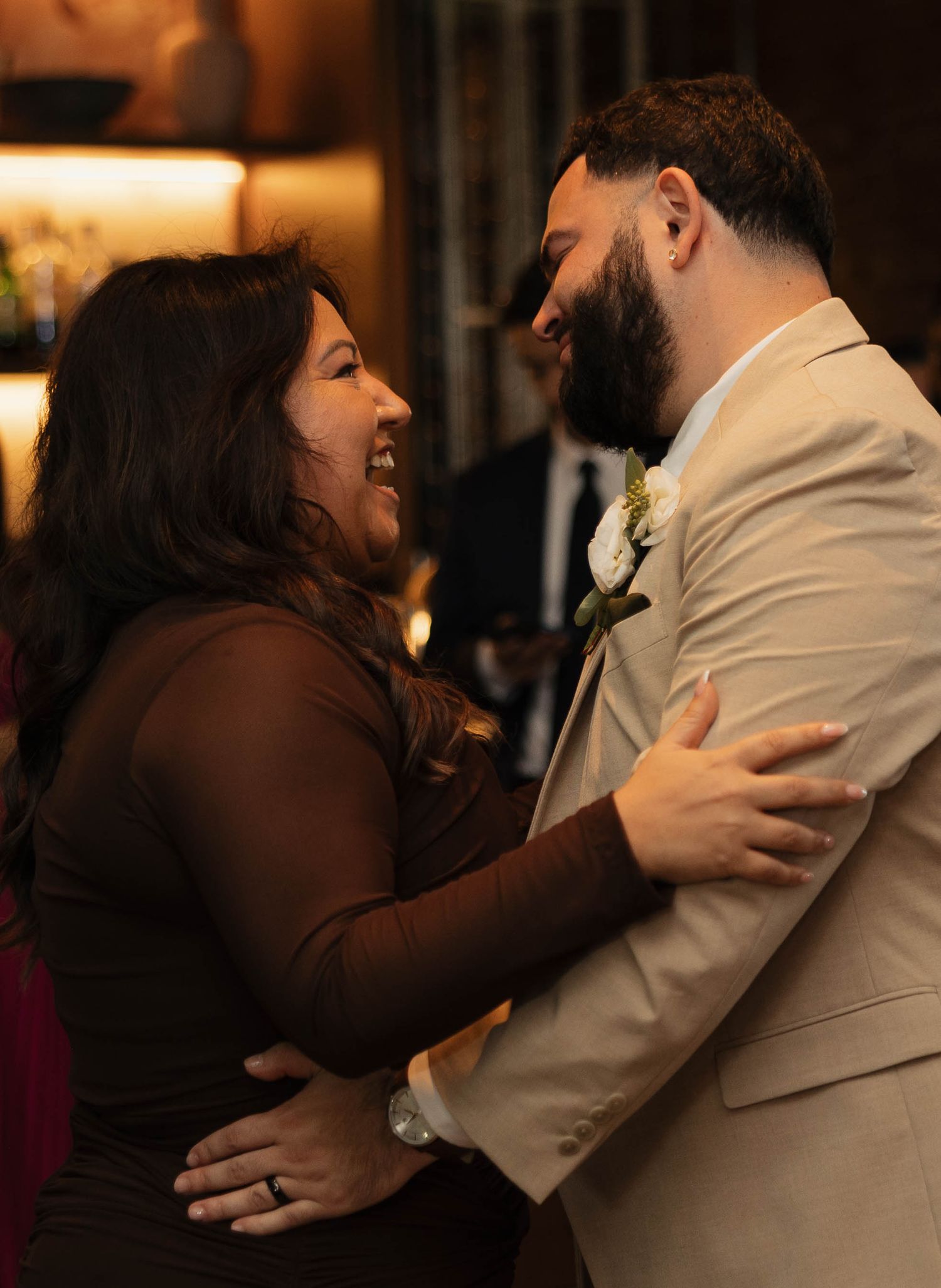 Candid sequence of a couple's romantic dance moments in warm reception lighting.