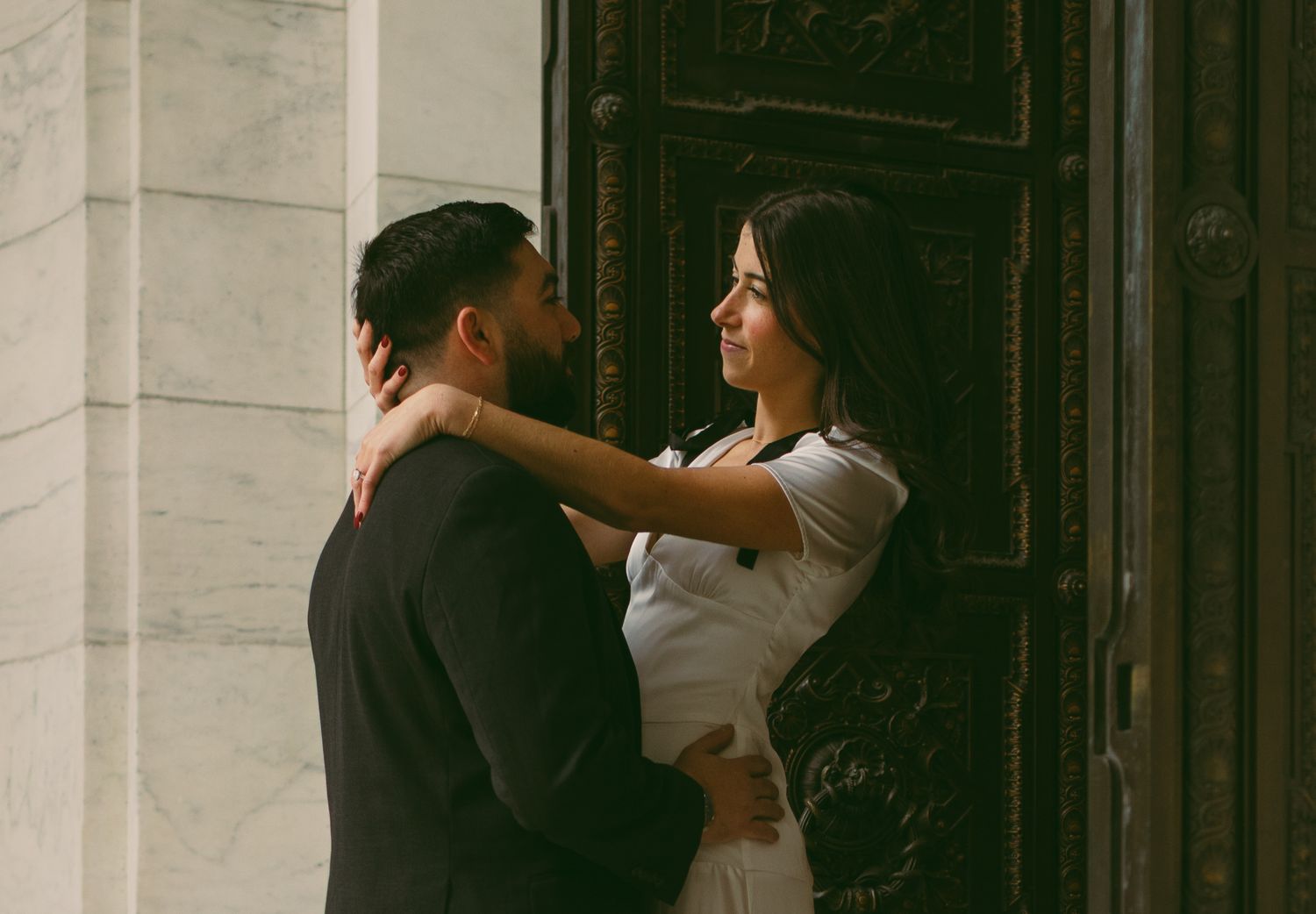 A romantic moment captured between a couple in formal attire.