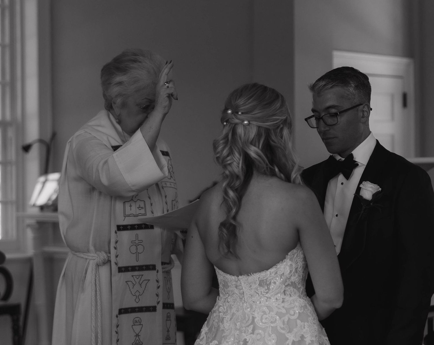 Wedding guests and couple sharing intimate moments during an indoor reception.