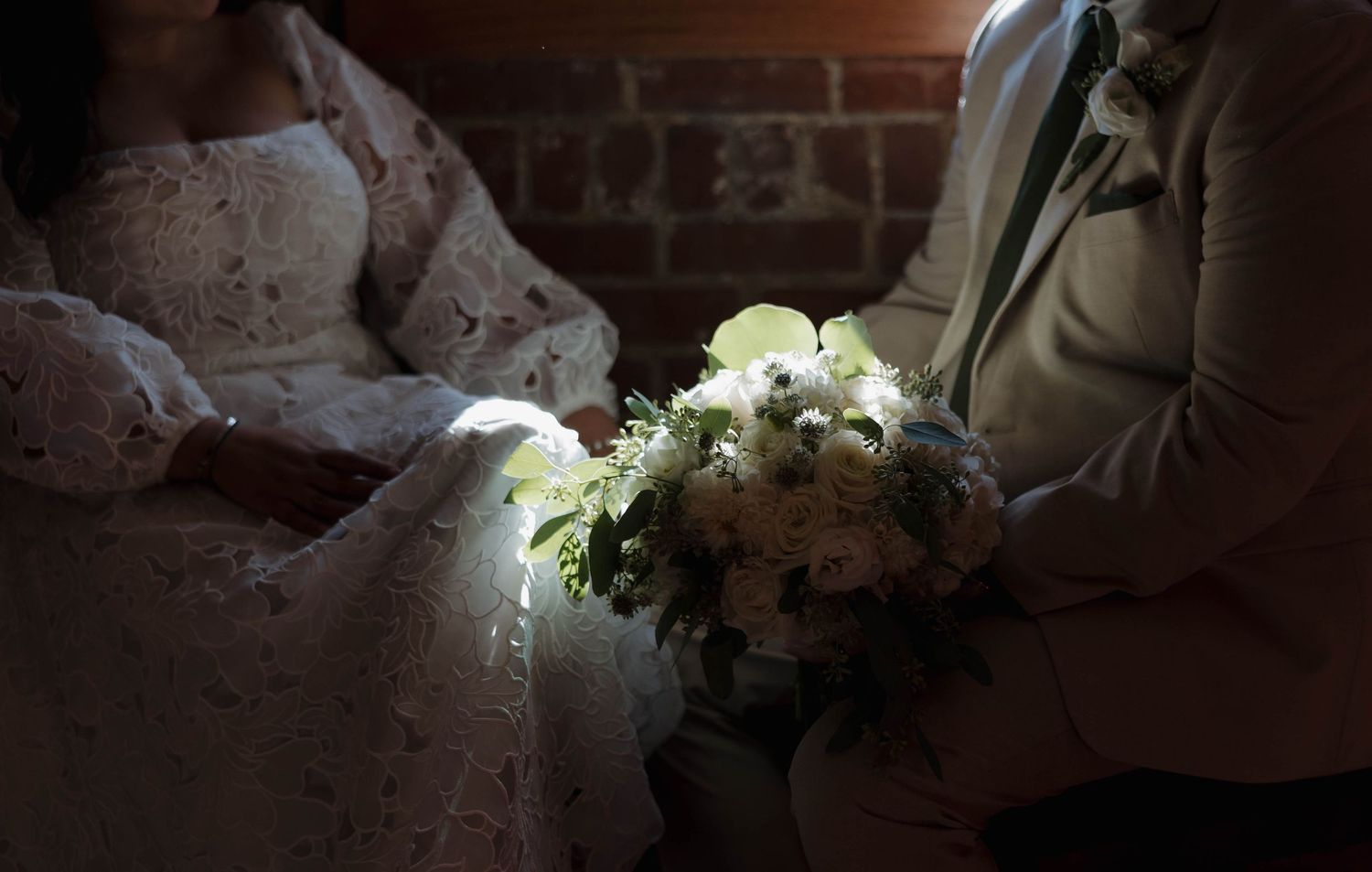 Sunlight streams through windows creating dramatic shadows in wedding photography session.