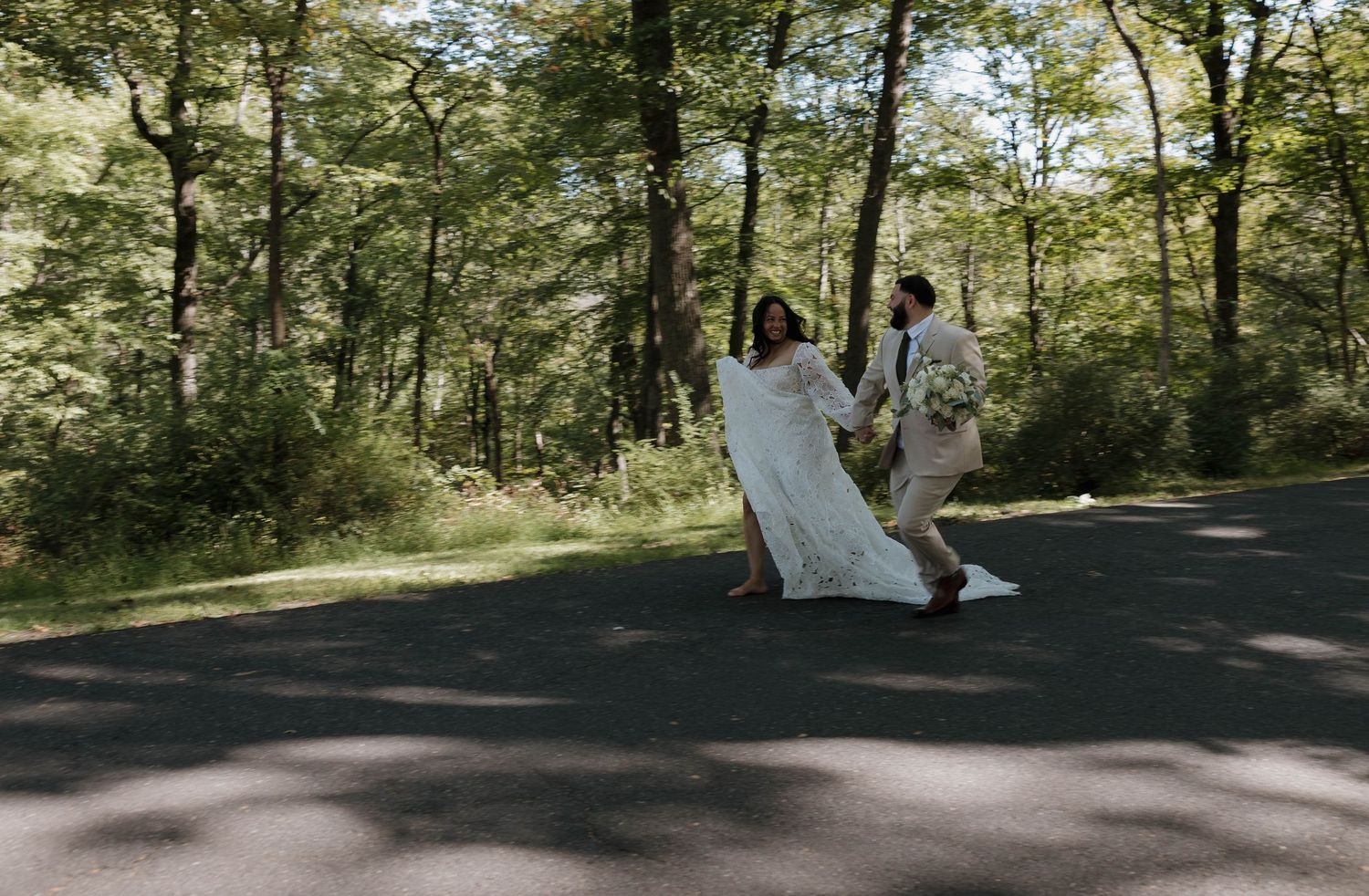 Forest wedding venue with sunlight streaming through trees.