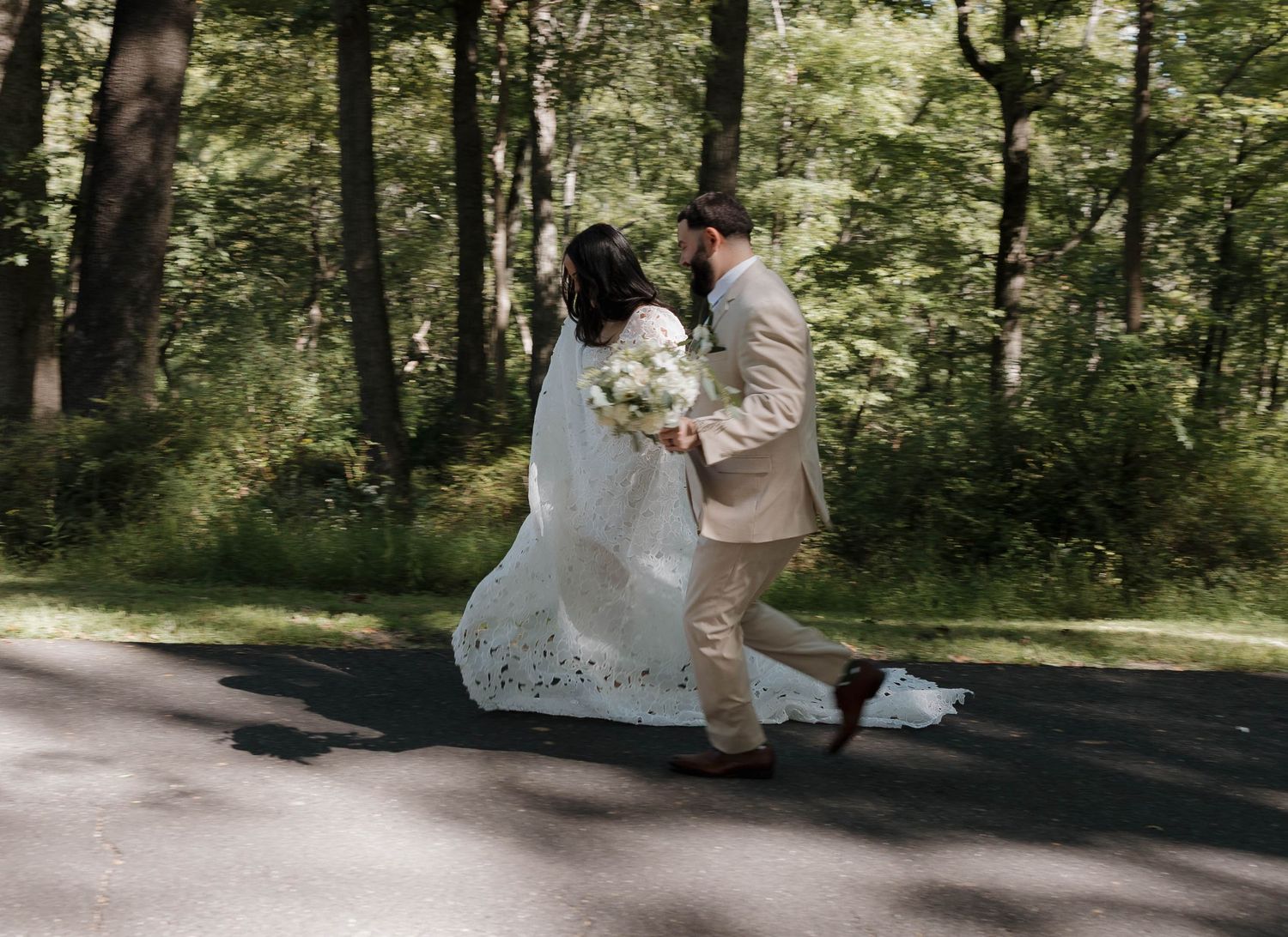 Wooded wedding venue path with natural lighting and shadows.