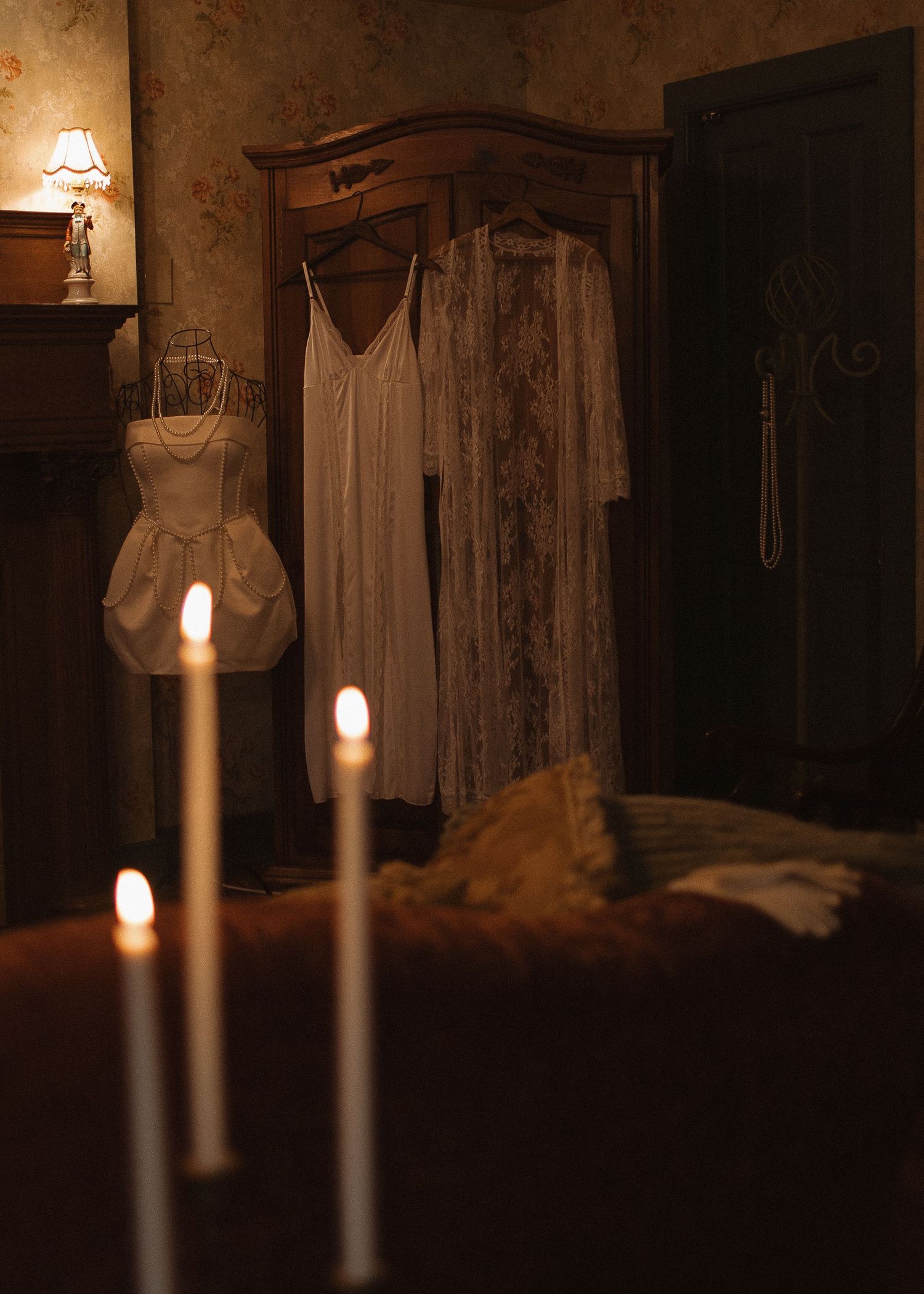 Vintage room interior lit by glowing candles creating a warm atmospheric ambiance.