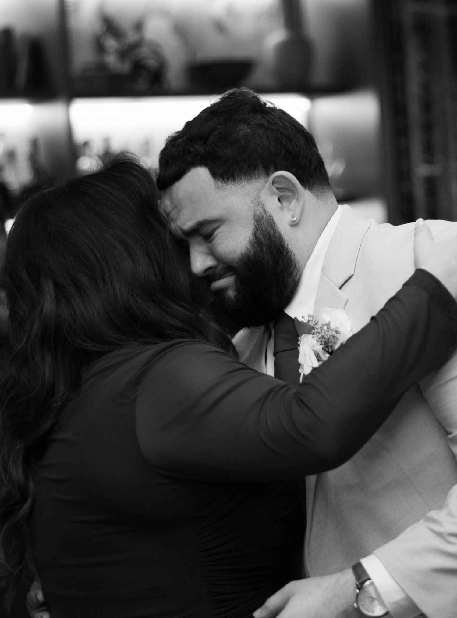 Black and white photo sequence of a couple's emotional first dance at their wedding reception.