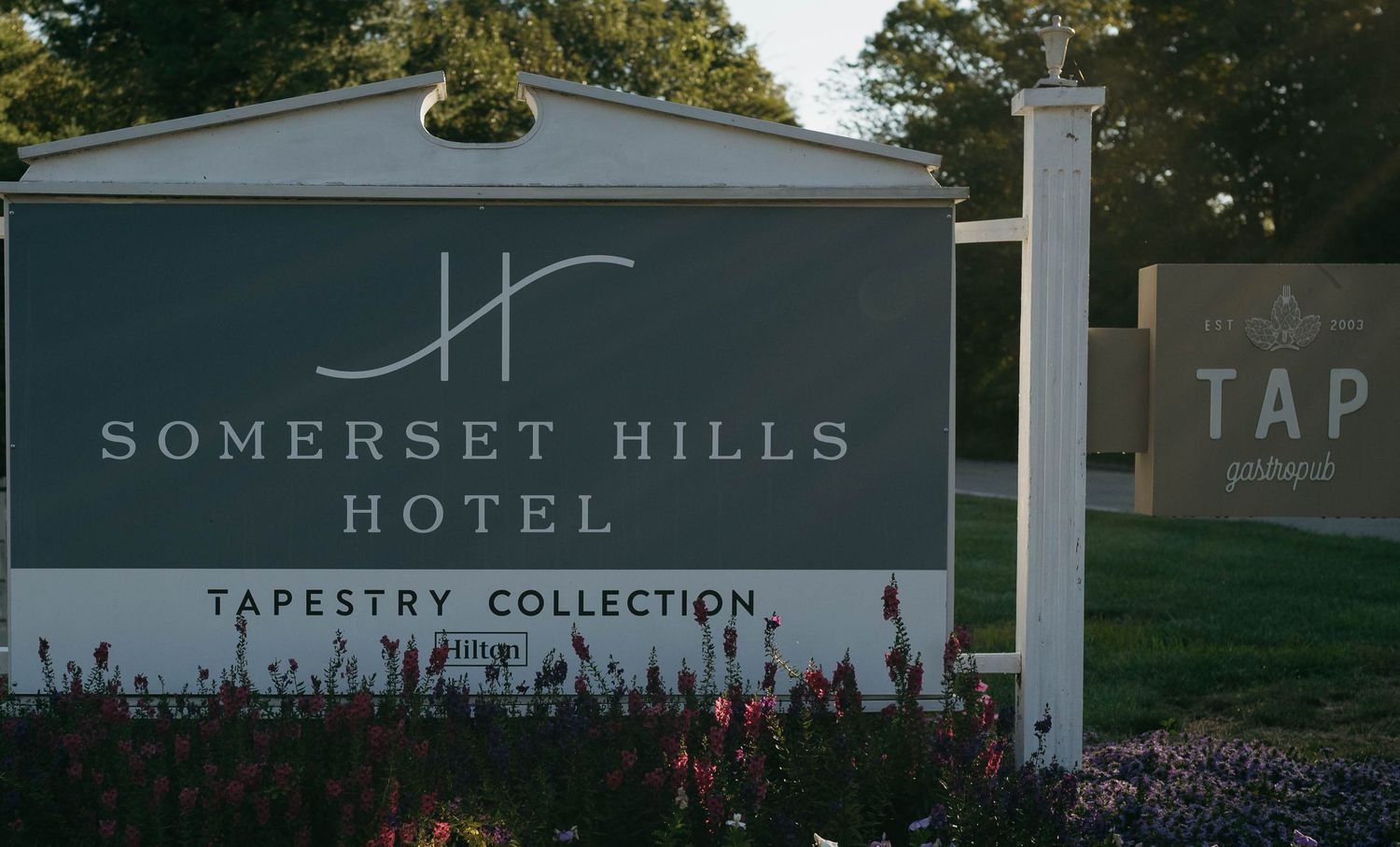 Somerset Hills Hotel entrance sign with Tapestry Collection branding and landscaping.