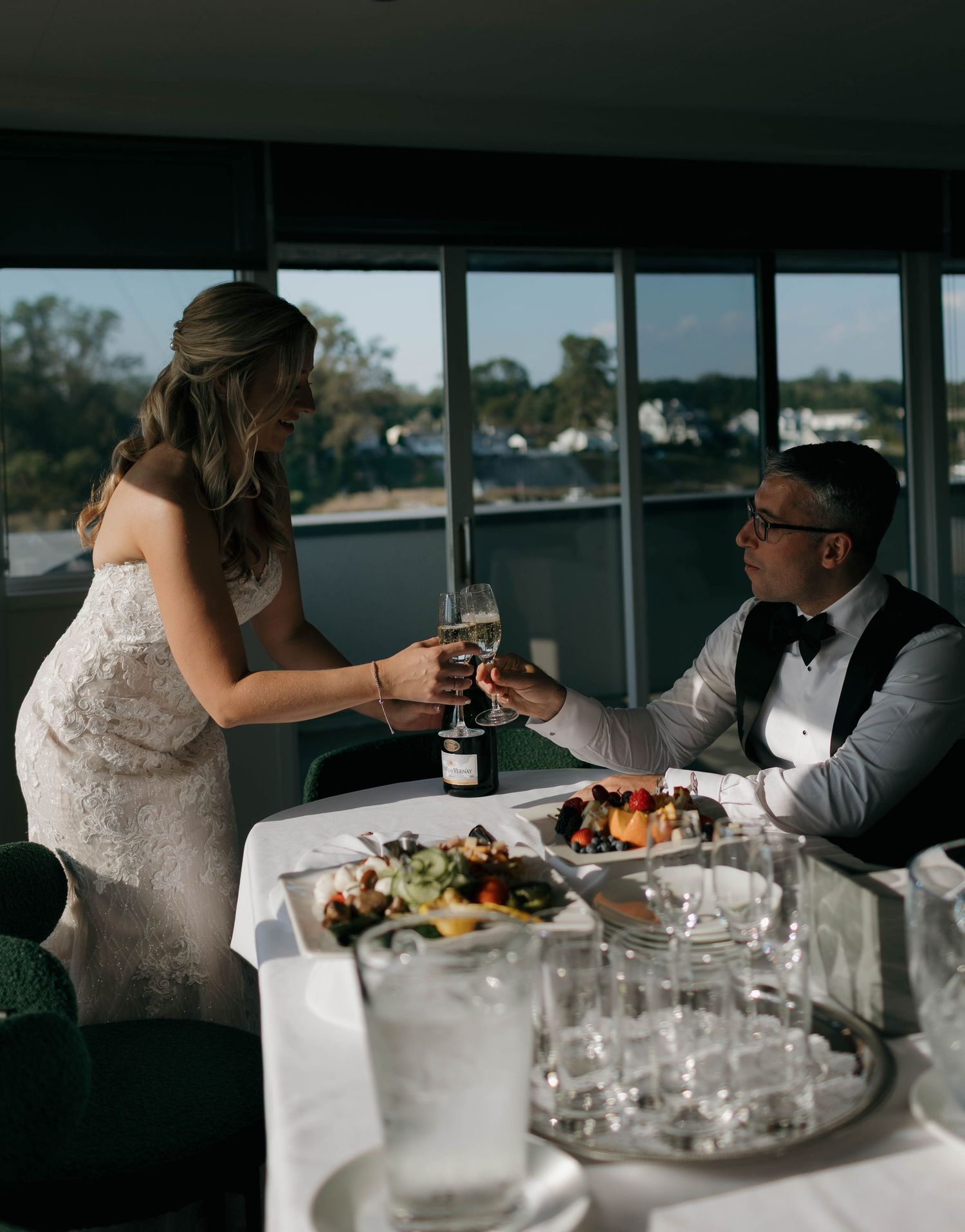 Wedding reception guests dining at an elegant waterfront venue.