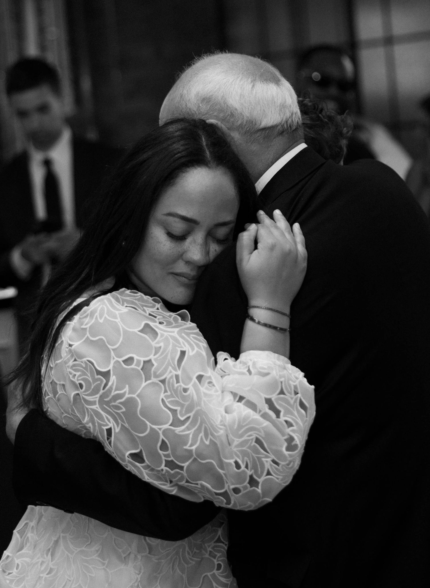 Artistic black and white shots of a wedding couple embracing during their reception dance.