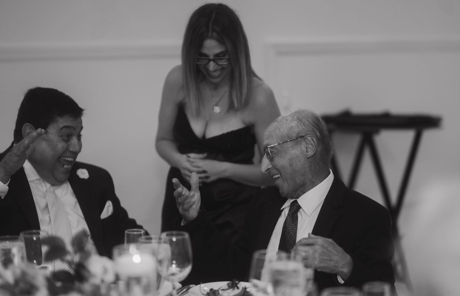 Black and white candid reception photos of wedding guests enjoying the celebration.