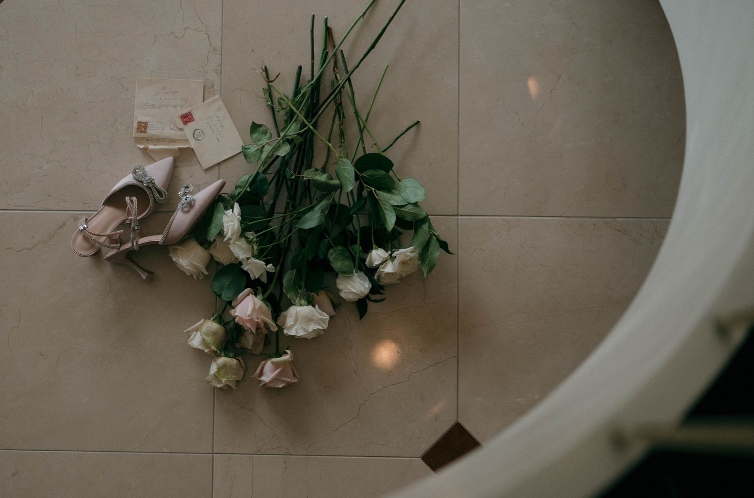 White roses and decorative elements arranged on a curved surface.