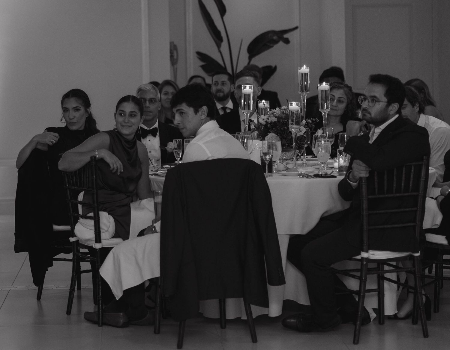 Guests seated at elegant tables during a formal evening event.