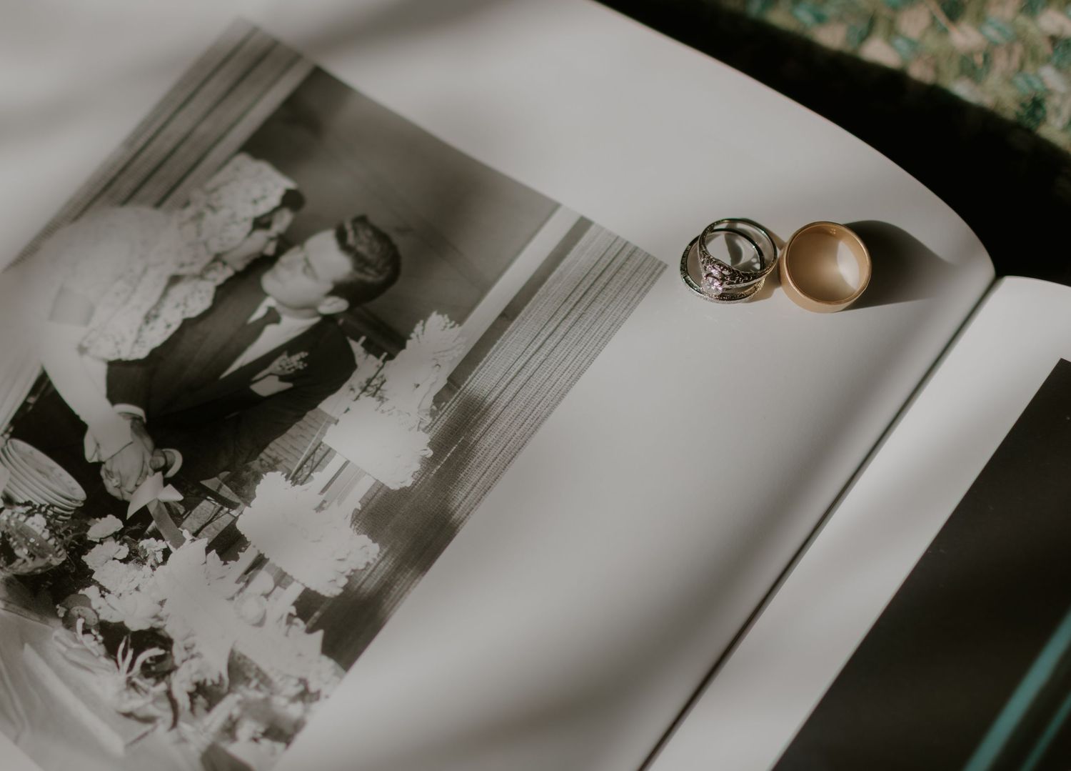 Black and white vintage photographs laid out on a light surface.