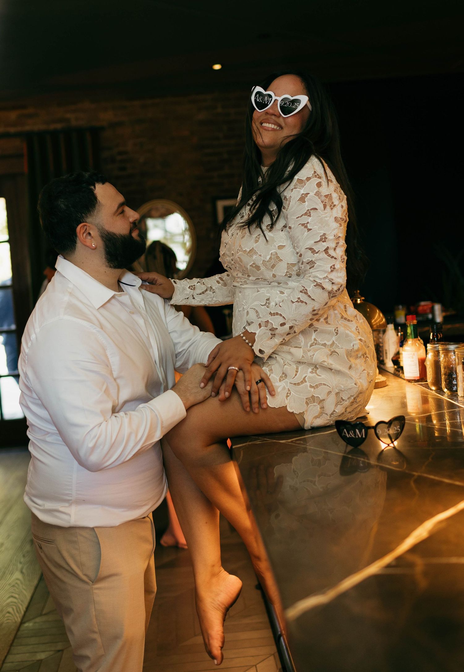 Playful dance sequence at a bar showing movement and laughter between two people.