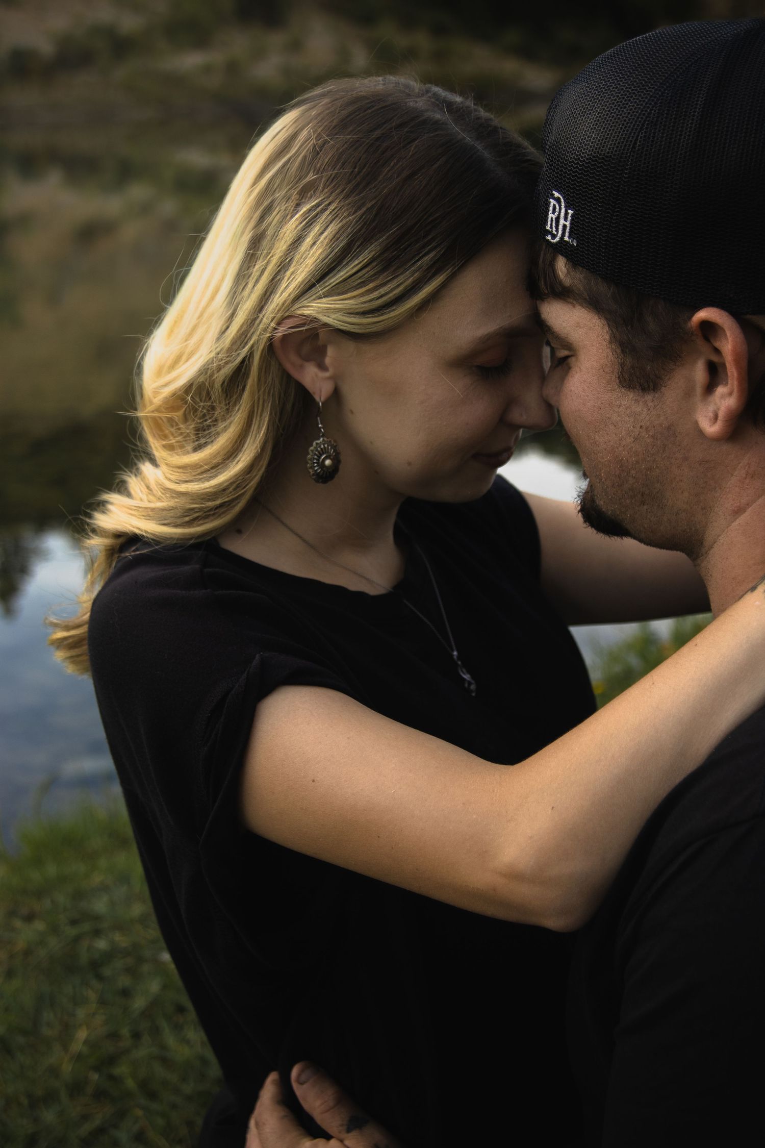 A romantic couple sharing intimate moments in a series of silhouetted poses against a natural backdrop.