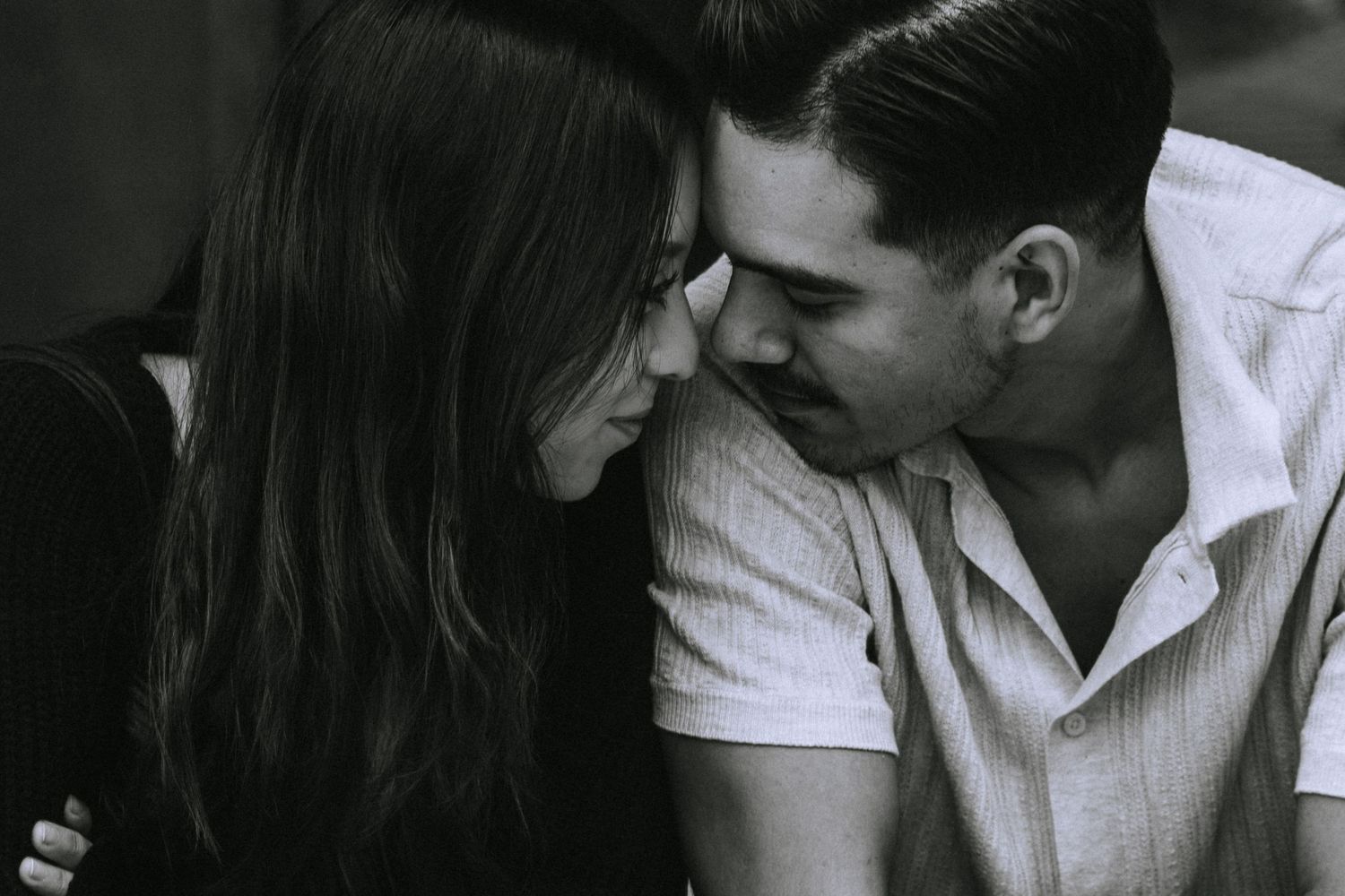 A romantic black and white moment between two people sharing an intimate close conversation.