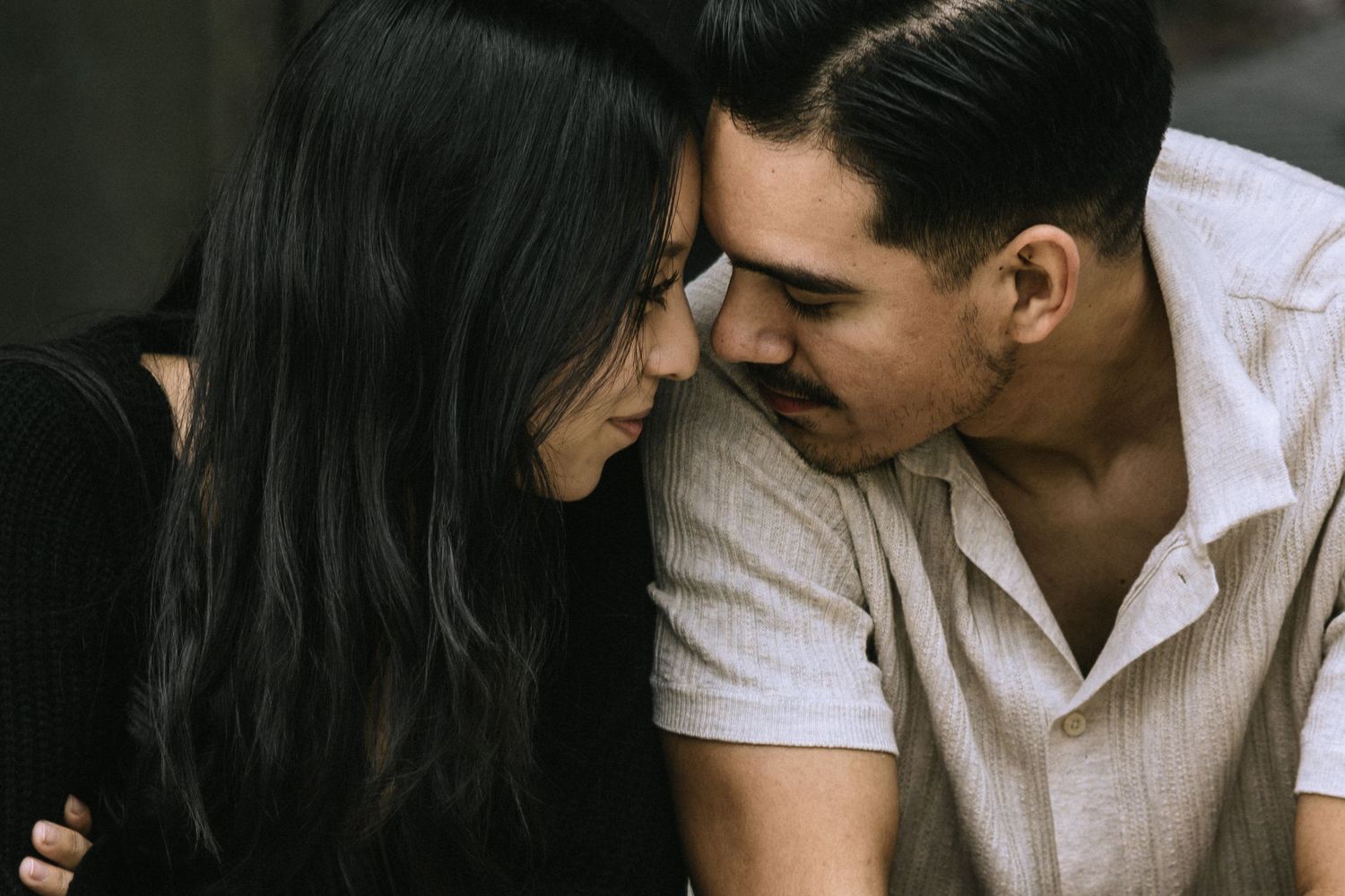 Intimate moment shared between couple during outdoor photoshoot.