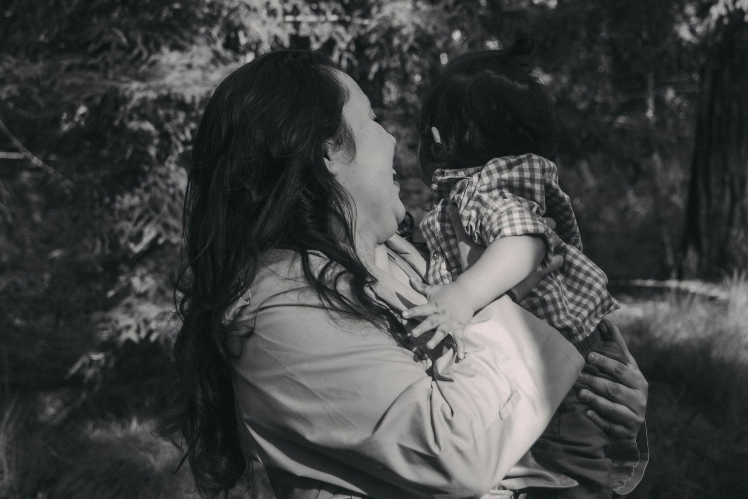 A black and white photo collage shows tender moments of a couple embracing in nature.