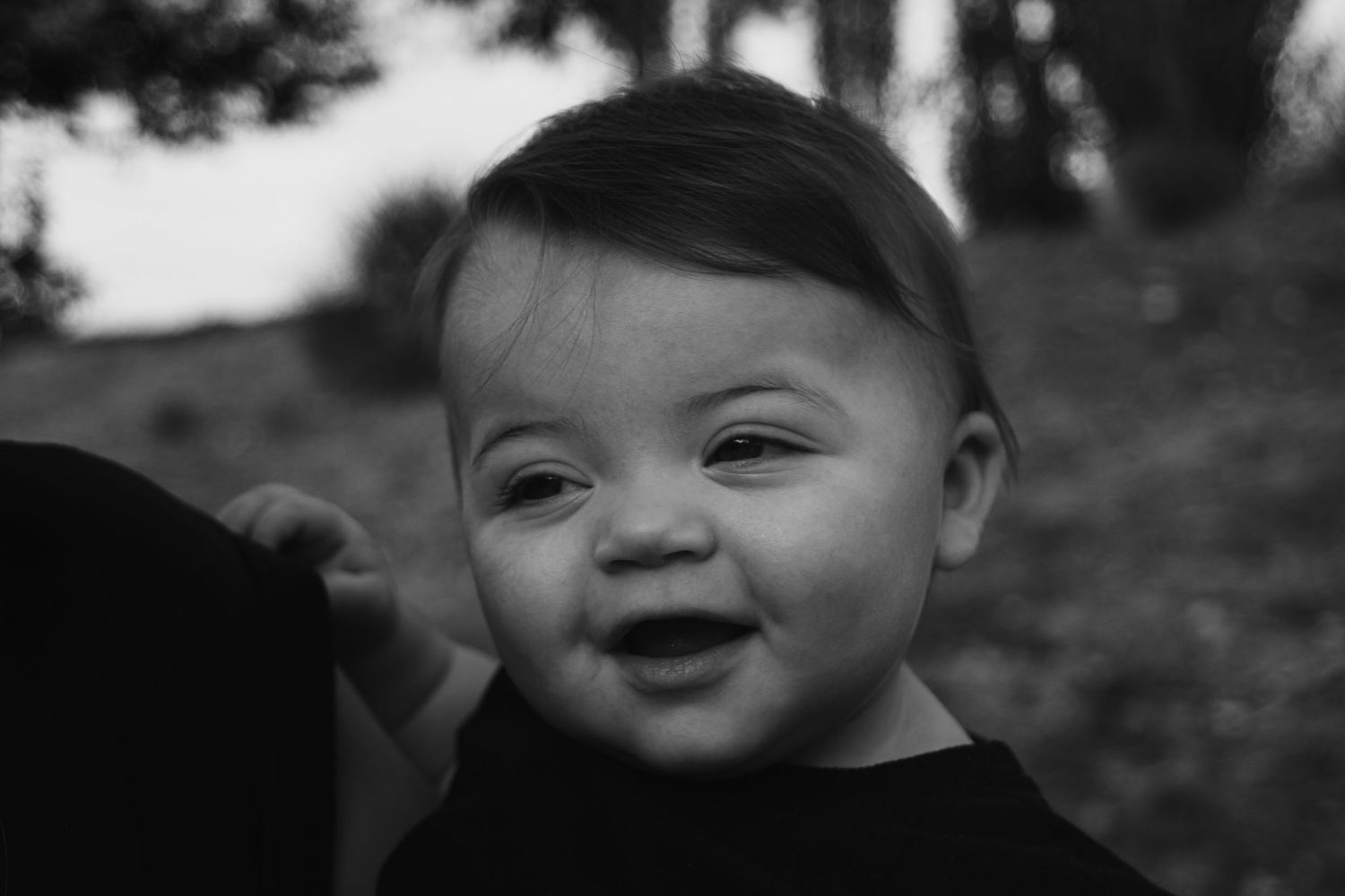Black and white close-up portraits showing joyful expressions and smiles.