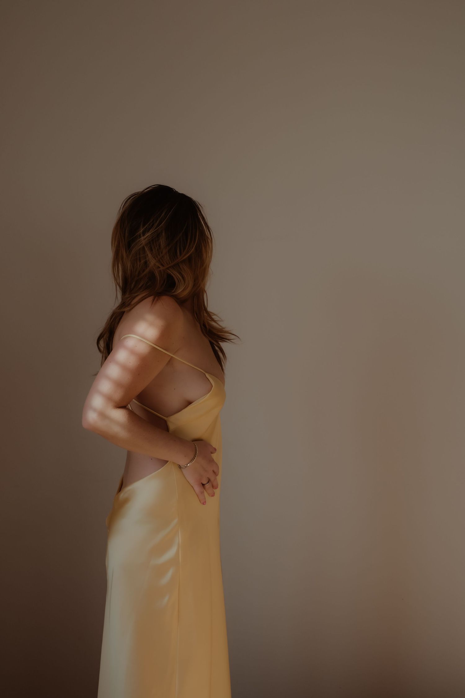 Vrouw van achteren gefotografeerd tijdens een zachte boudoir fotoshoot