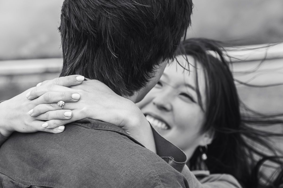 Black and white photograph of a couple in the quiet, breathless moment of a proposal