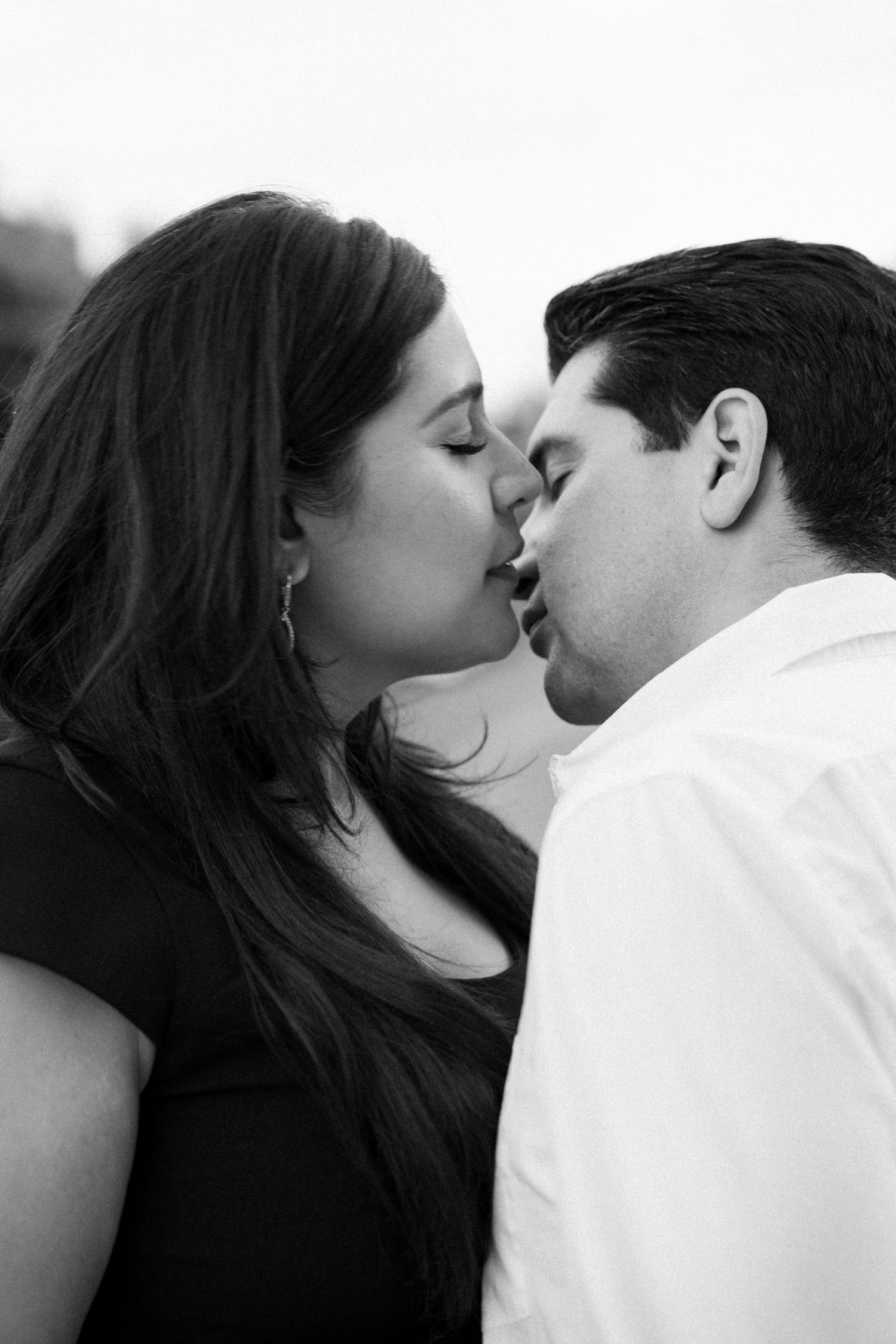Black and white photograph of a couple in the quiet, breathless moment of a proposal