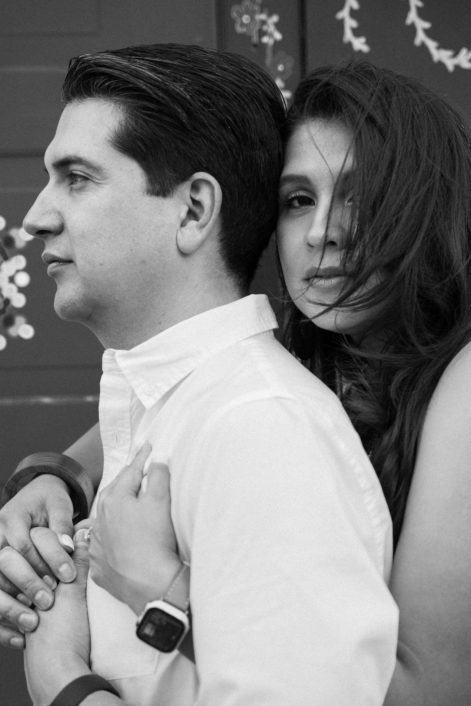 Black and white photograph of a couple in the quiet, breathless moment of a proposal