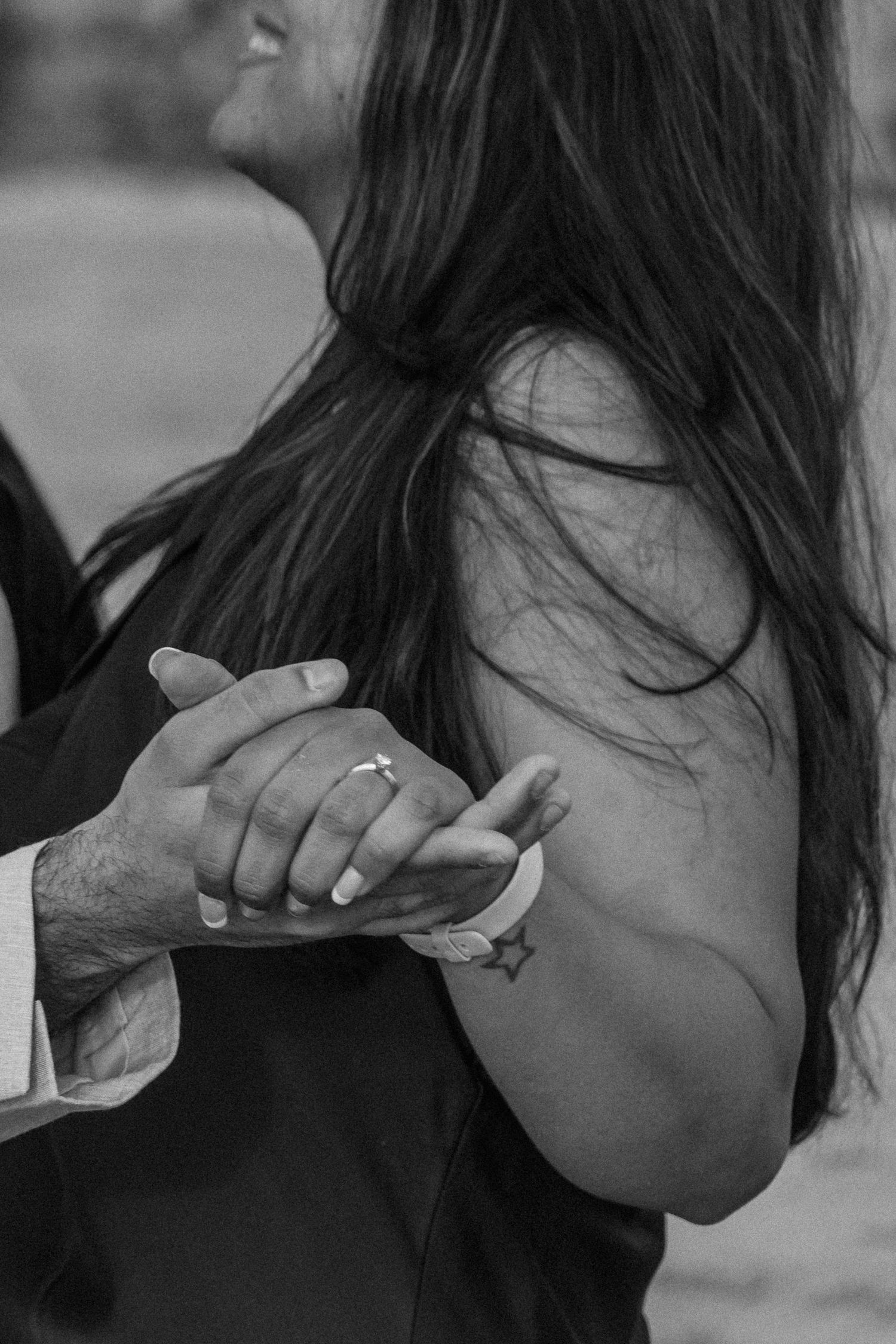 Black and white photograph of a couple in the quiet, breathless moment of a proposal