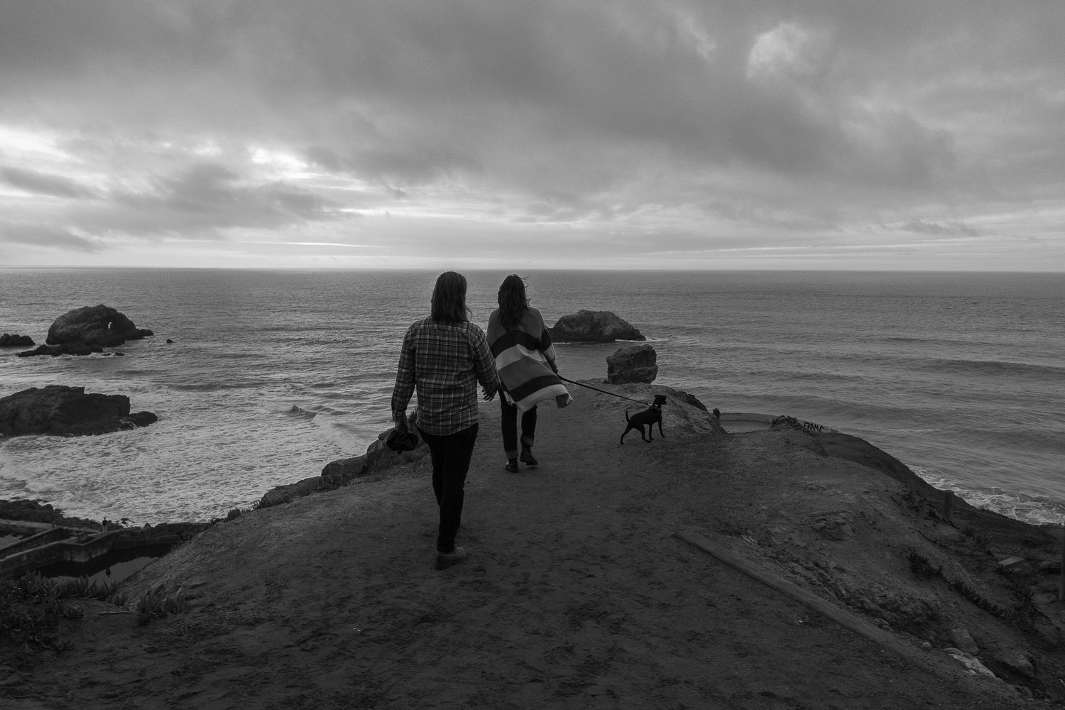 Black and white nature photograph of a couple in a ocean landscape