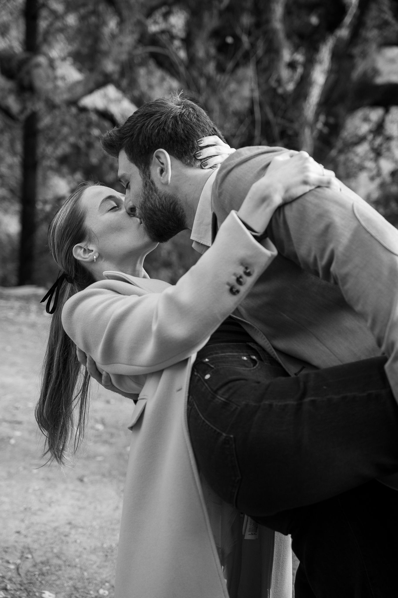 Black and white photograph of a couple in the quiet, breathless moment of a proposal