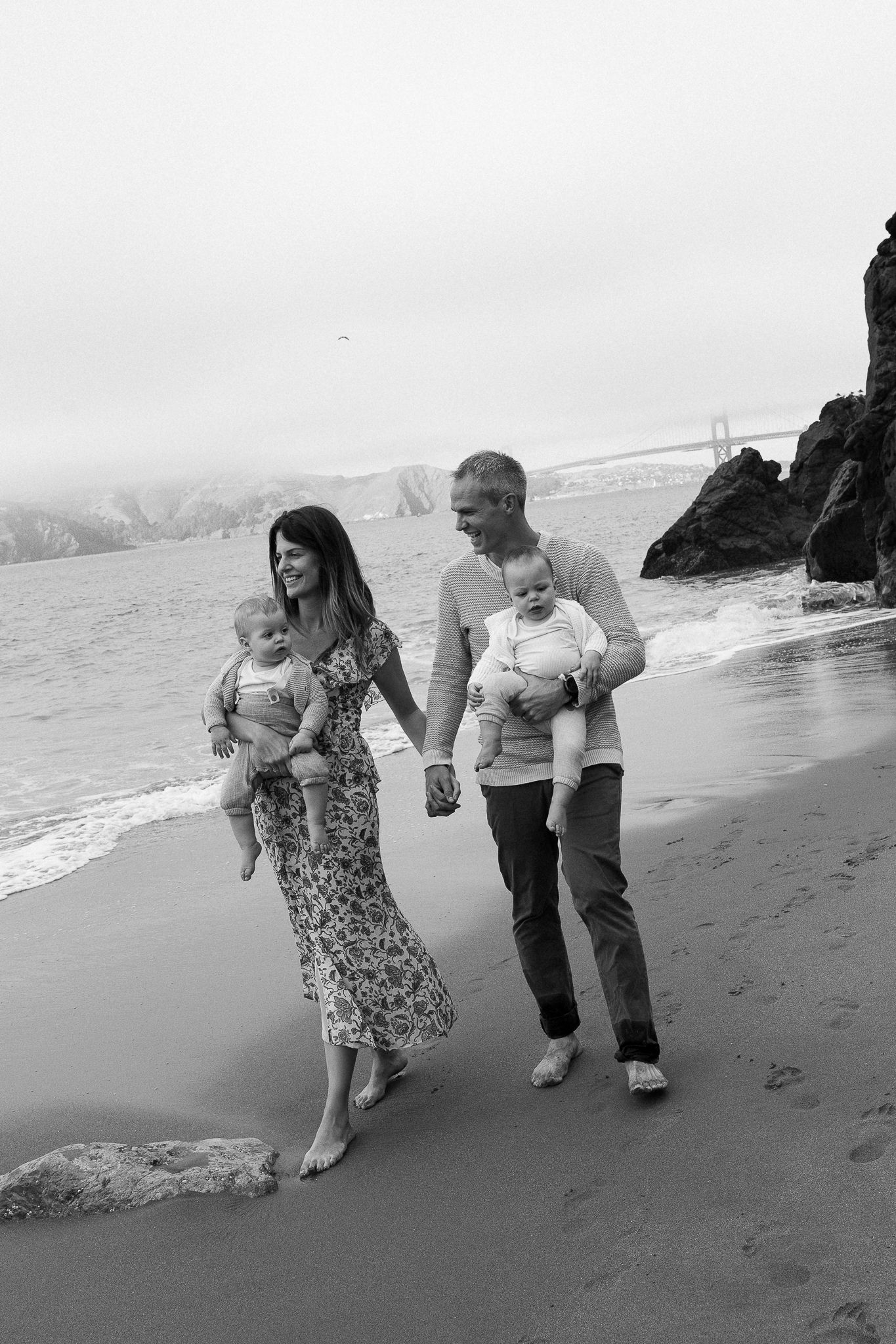 Black and white nature photograph of a family at the beach