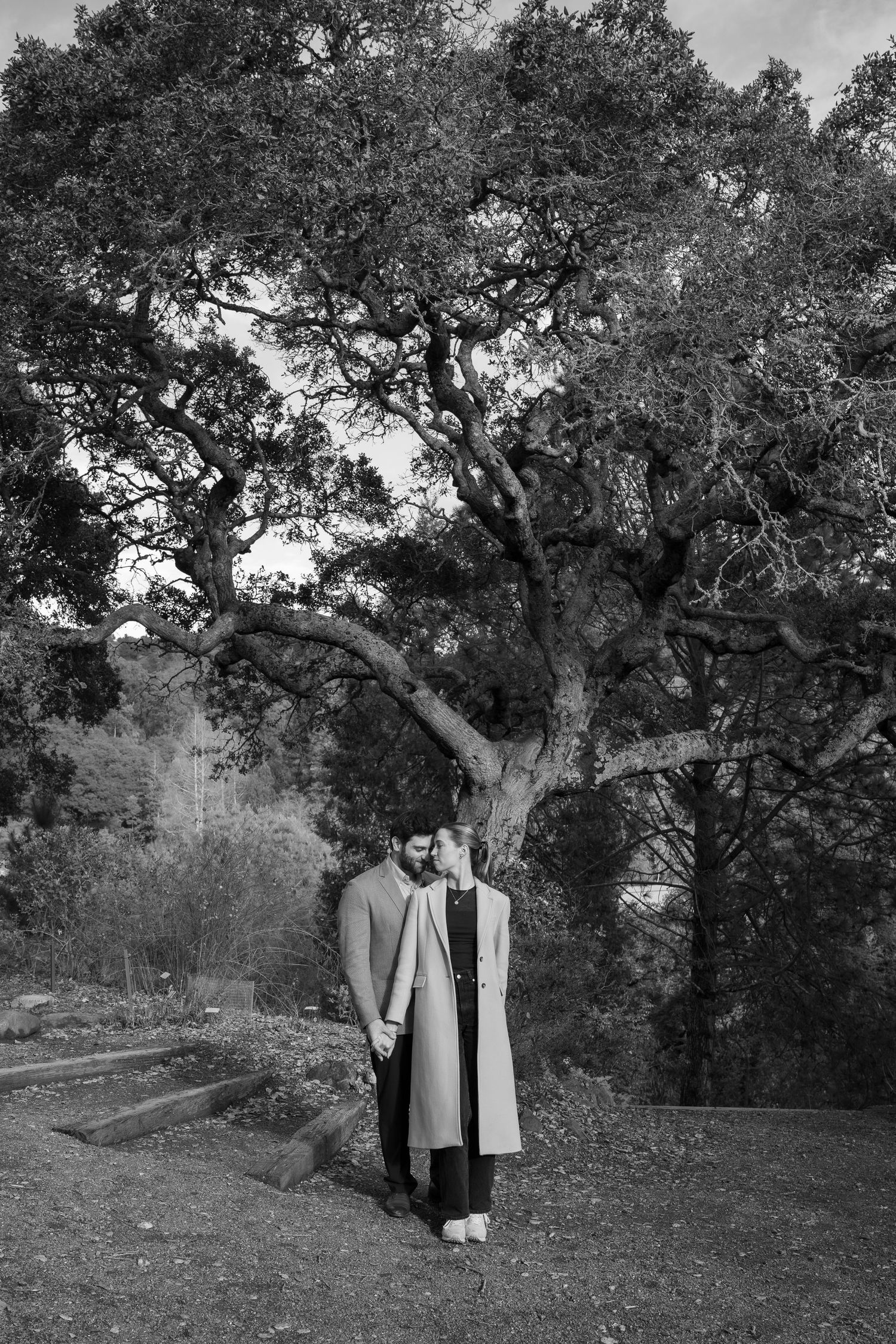 black and white photo of a couple during an engagement proposal
