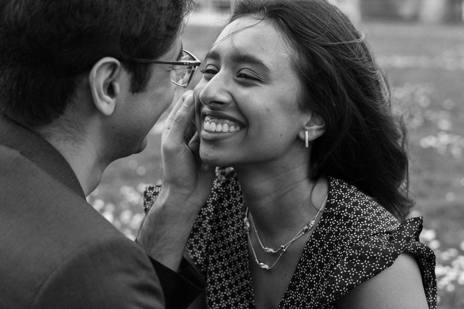 Black and white photograph of a couple in the quiet, breathless moment of a proposal