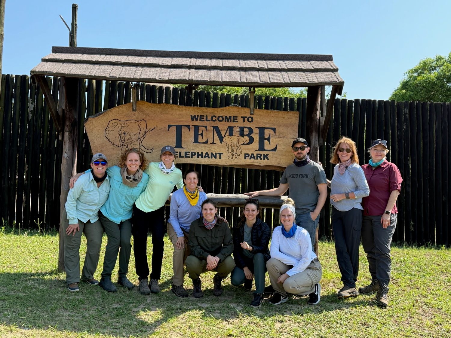 A group of people standing in front of a sign for the Tempe Diversion Channel.