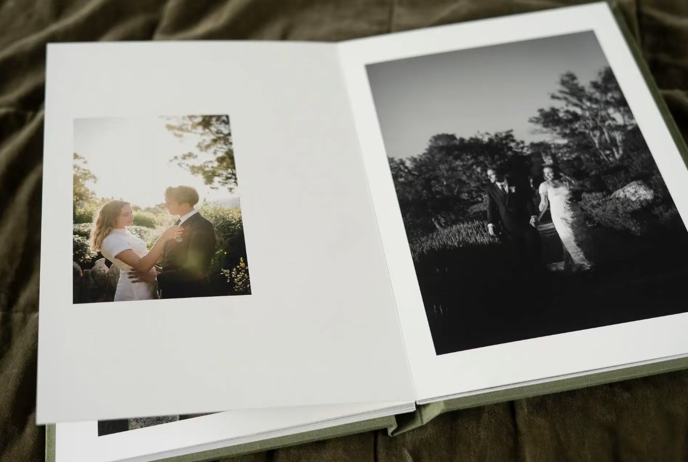 Open wedding photo book displaying romantic couple portrait and black and white outdoor photo in Cincinnati, Ohio